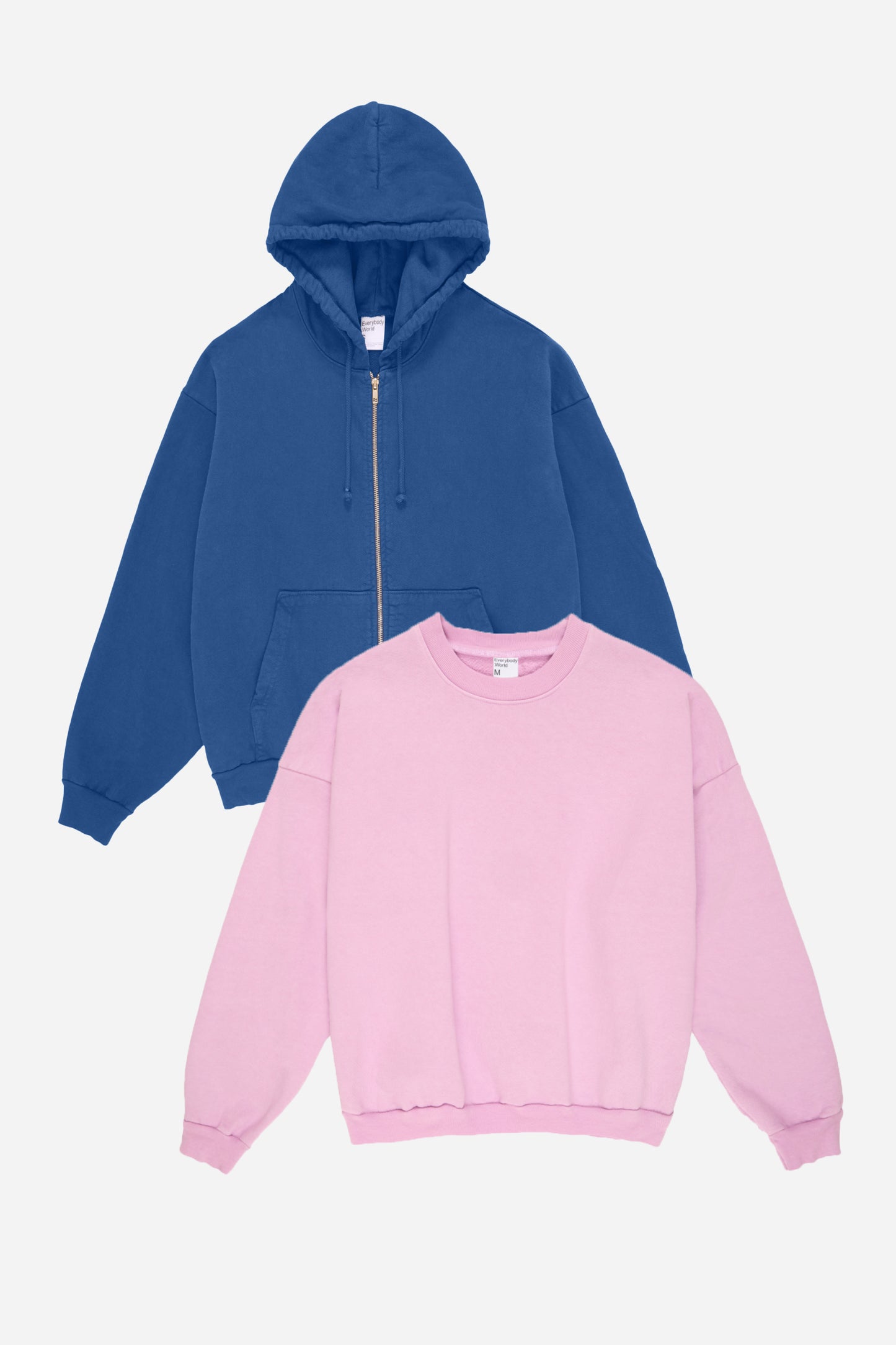 Flat lay of Denim blue hoodie and Lavender sweatshirt on a white background