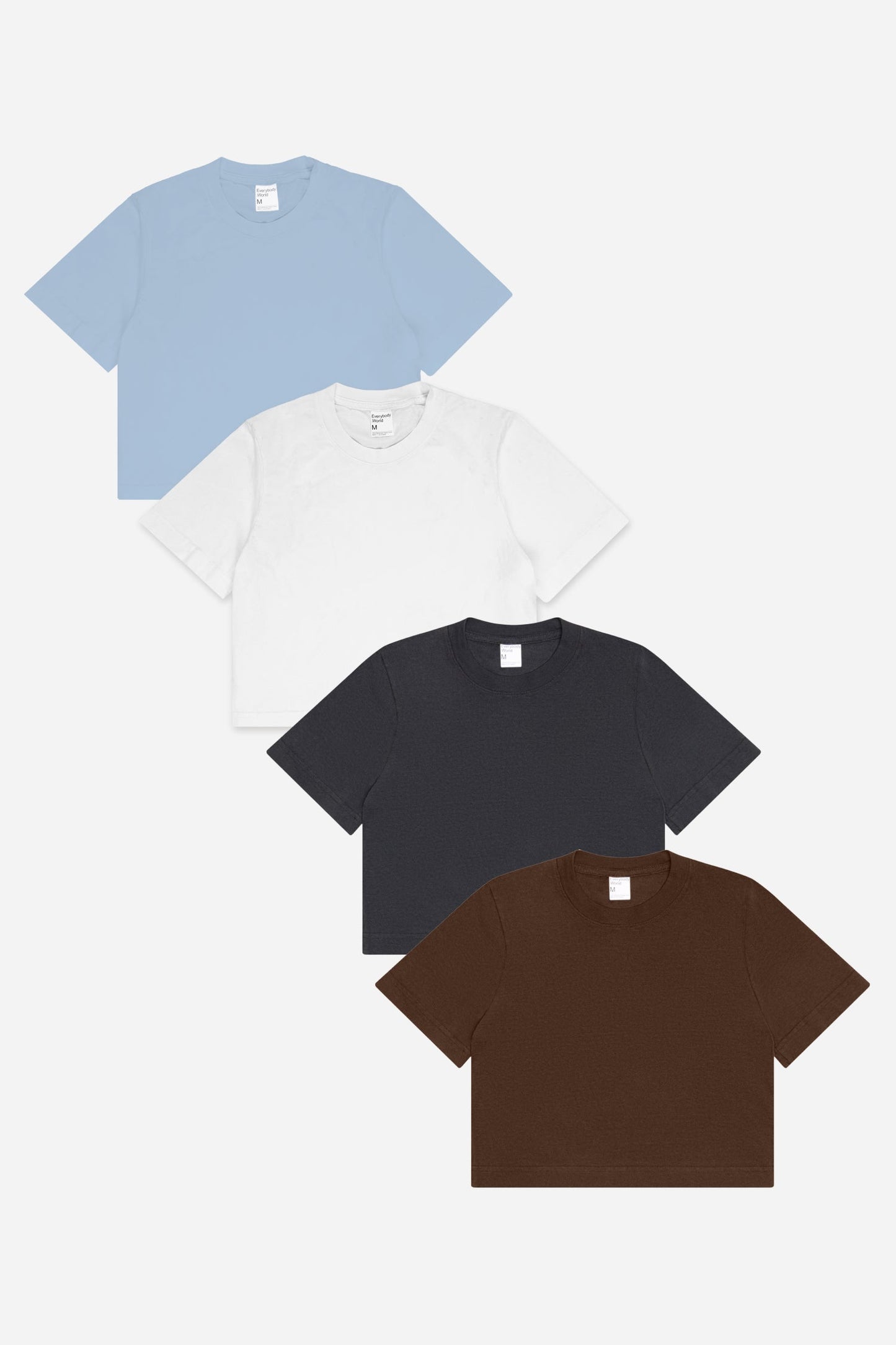 Flat lay of White, Slate and Fog (light blue) baby tees