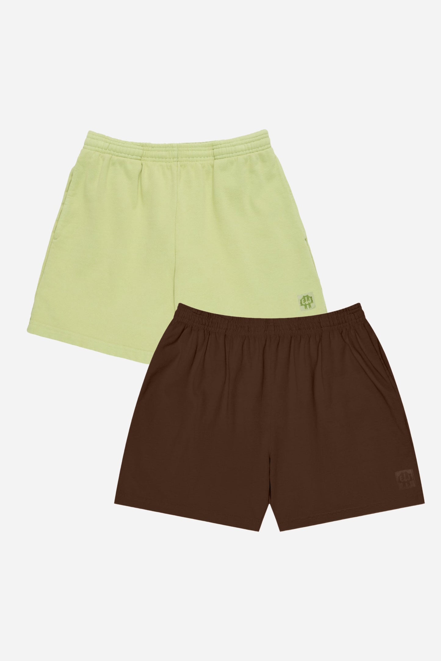 Two pairs of shorts, one green and one brown, on a white background.