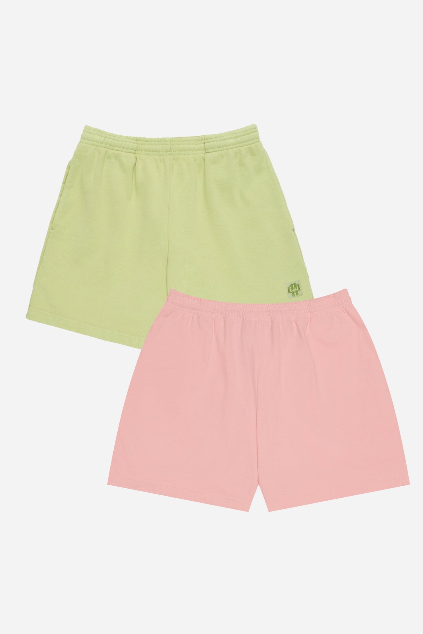Two pairs of shorts, one green and one pink, on a white background.
