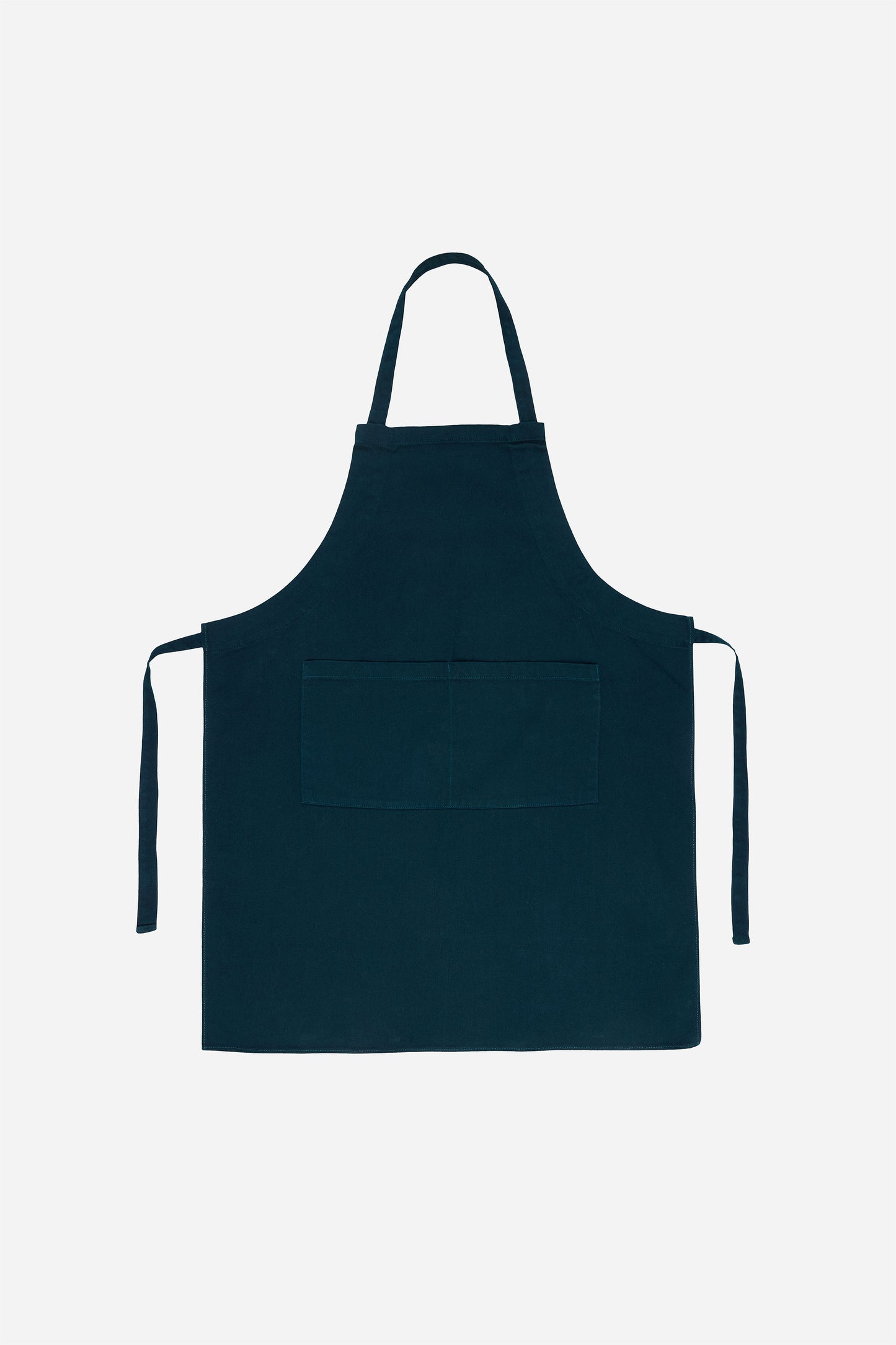 Flat lay of Adjustable Apron in Juniper with straps untied positioned to the sides of the apron.
