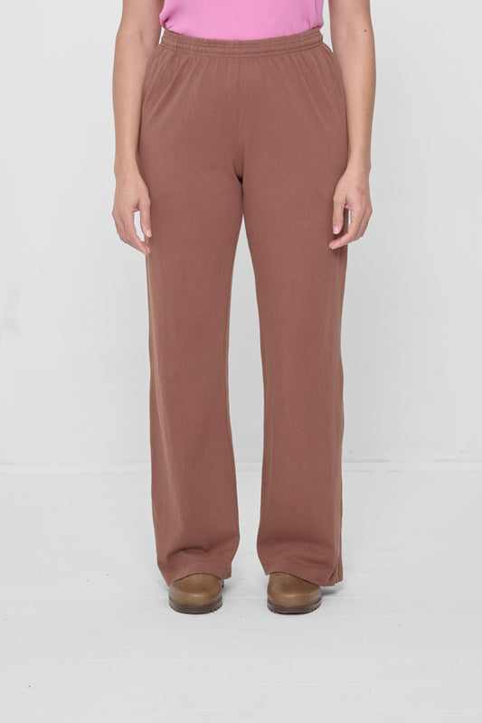 A 5'4" person in size M Potting soil Apartment Pants. Hem ends at the heels.