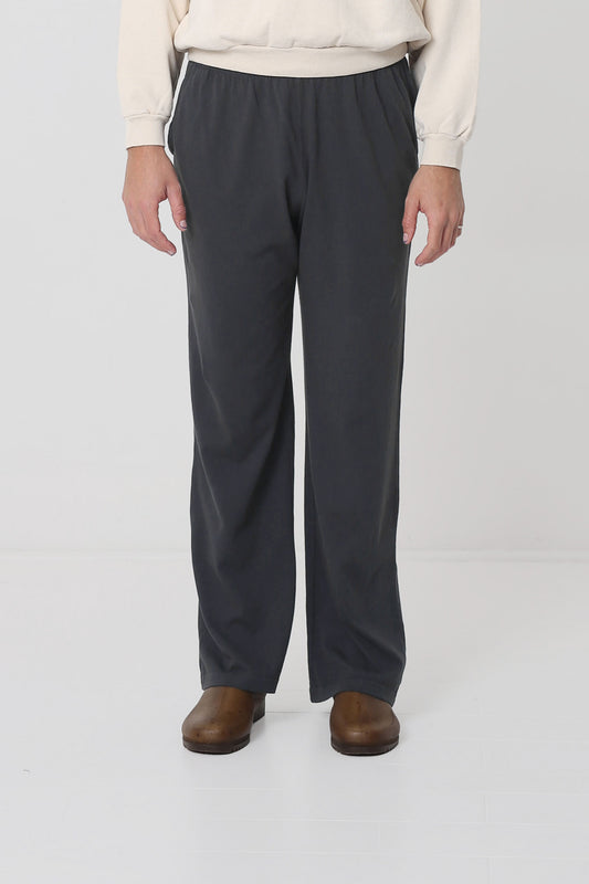 Waist down of a 6' person in Size L Slate Apartment Pants. Hem ends at the heel.