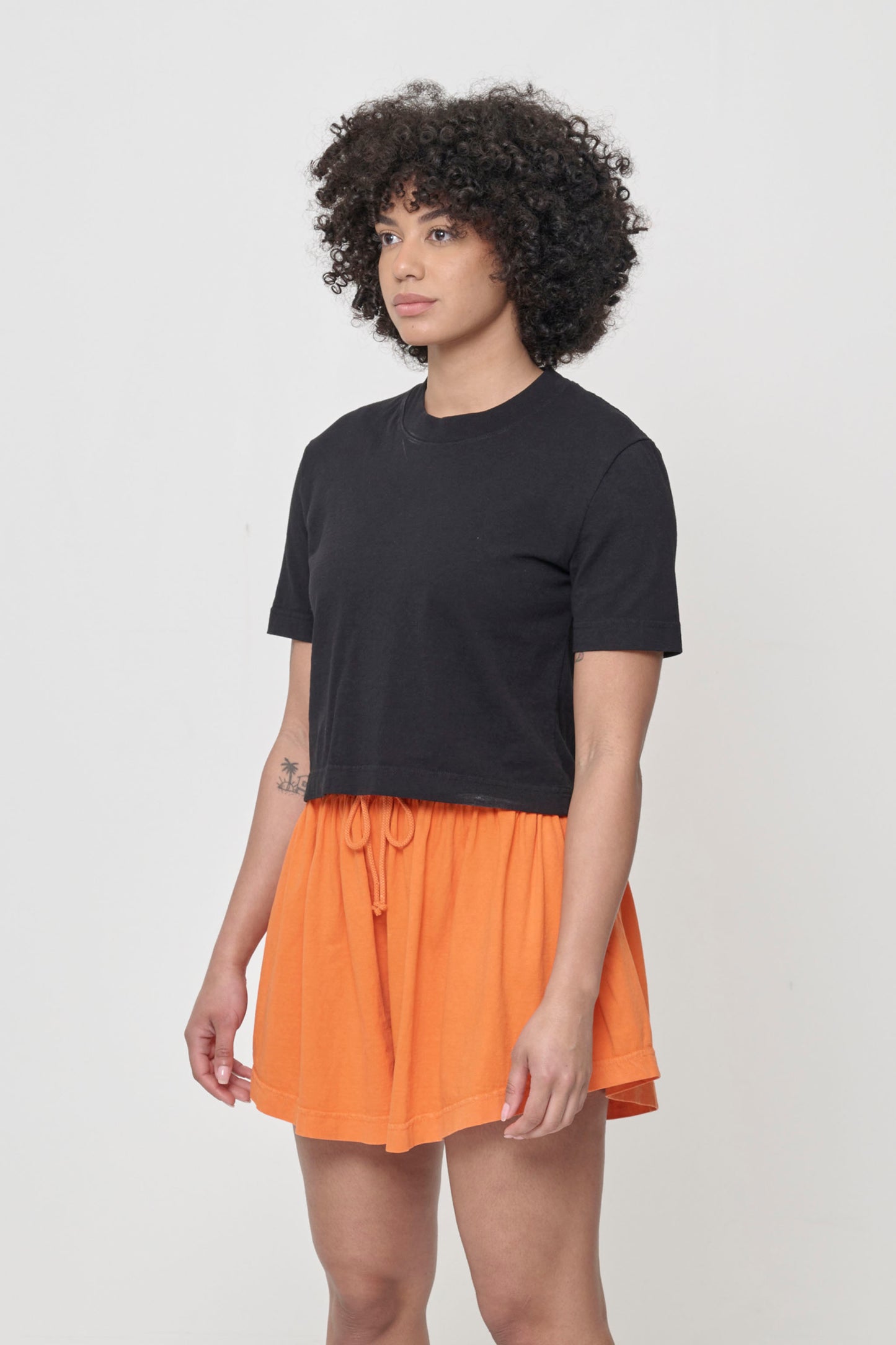 3/4 front view showing relaxed yet slim short sleeves and side seams.
