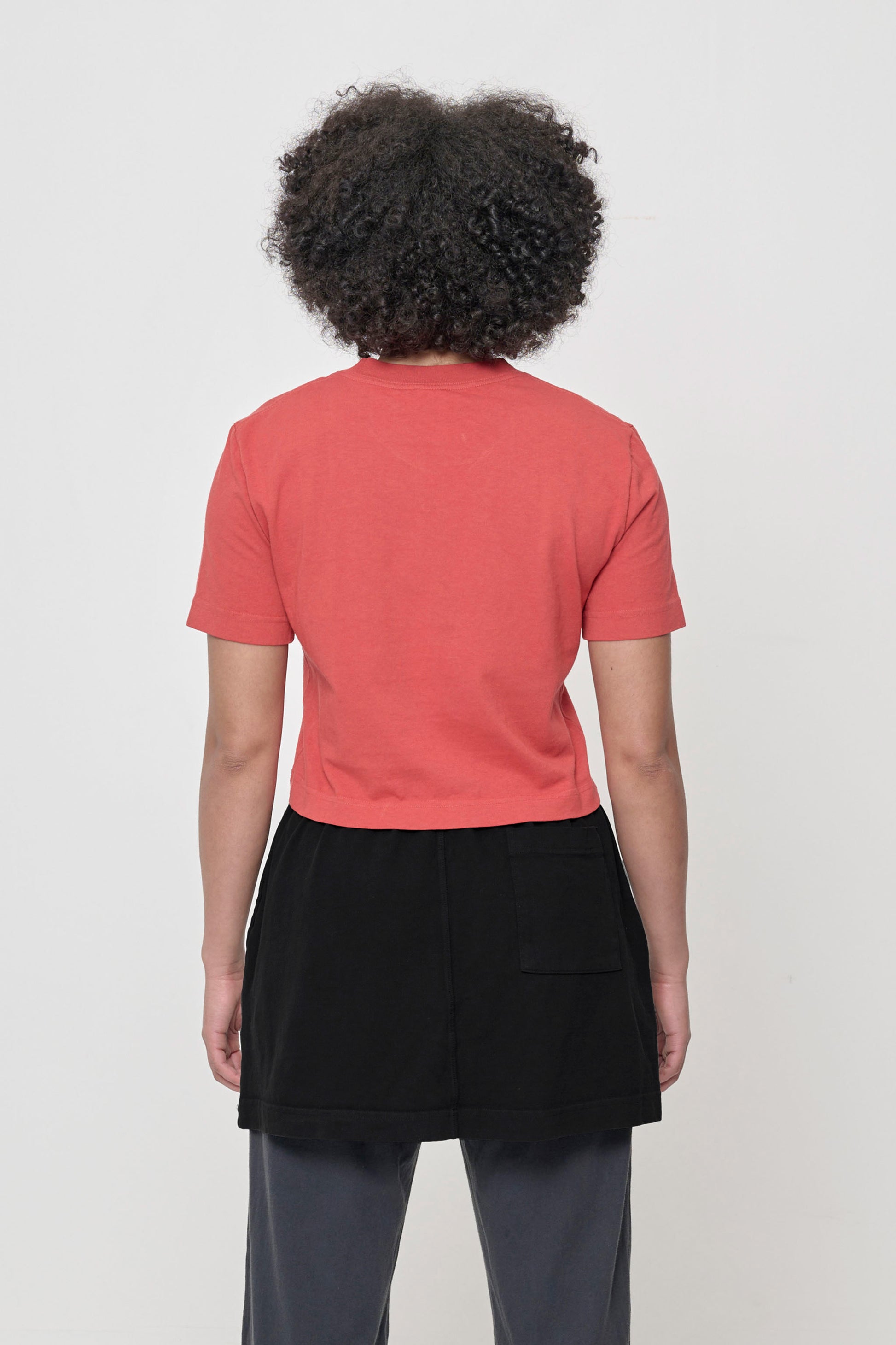 Back view showing cropped length and classic crew neck.