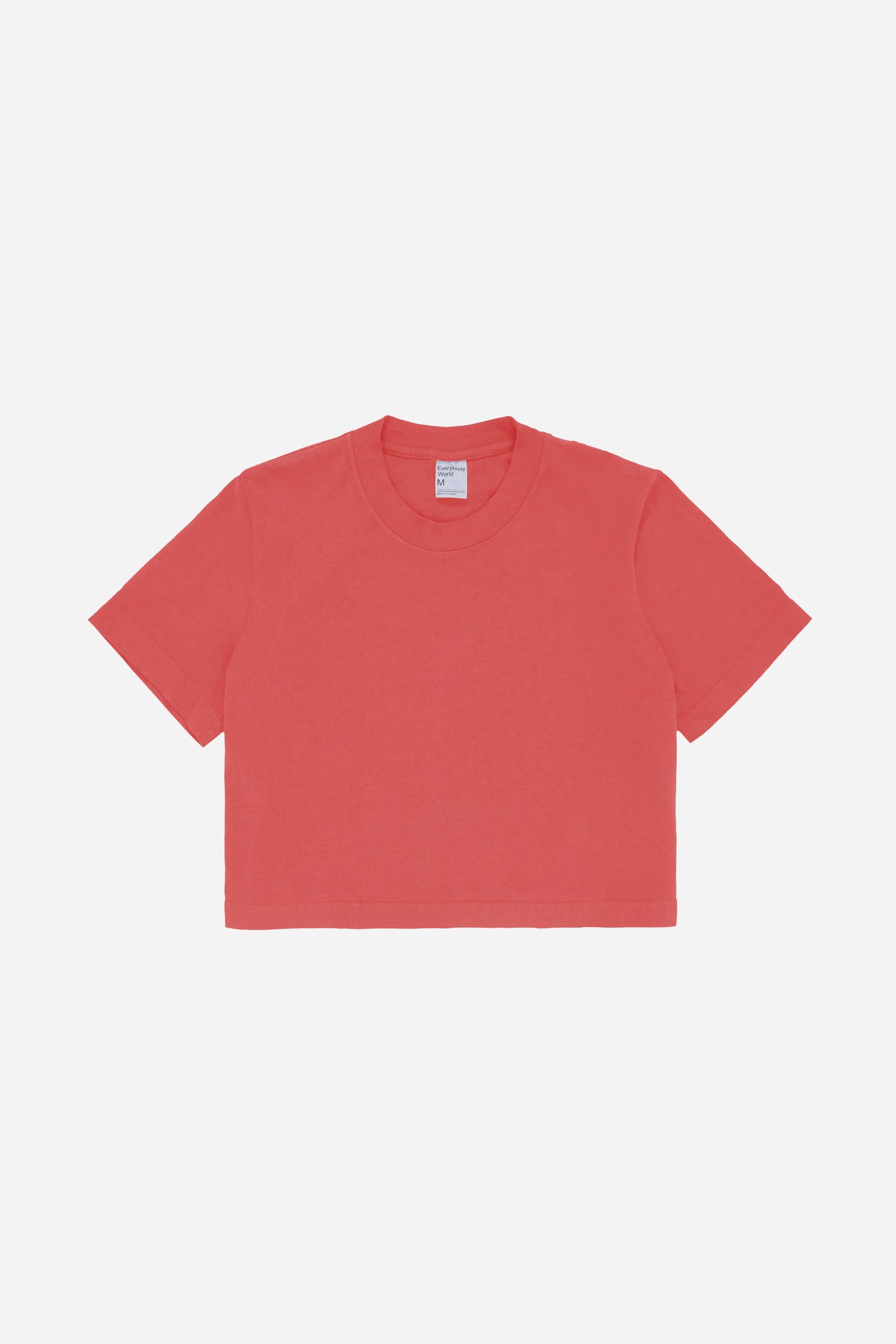 Flat lay showing orange-red t-shirt's silhouette and construction details