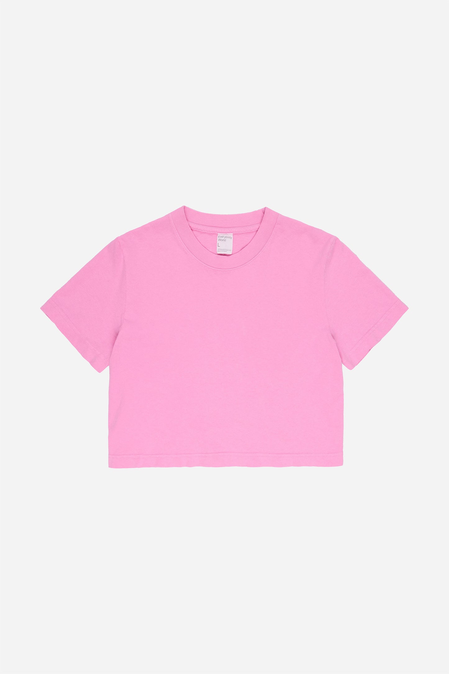Flat lay showing medium pink t-shirt's silhouette and construction details