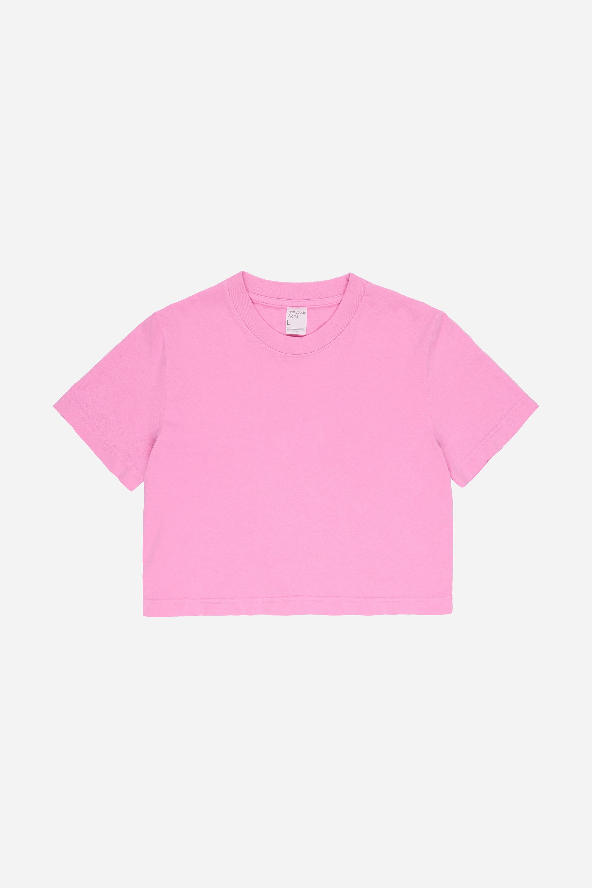 Flat lay showing medium pink t-shirt's silhouette and construction details