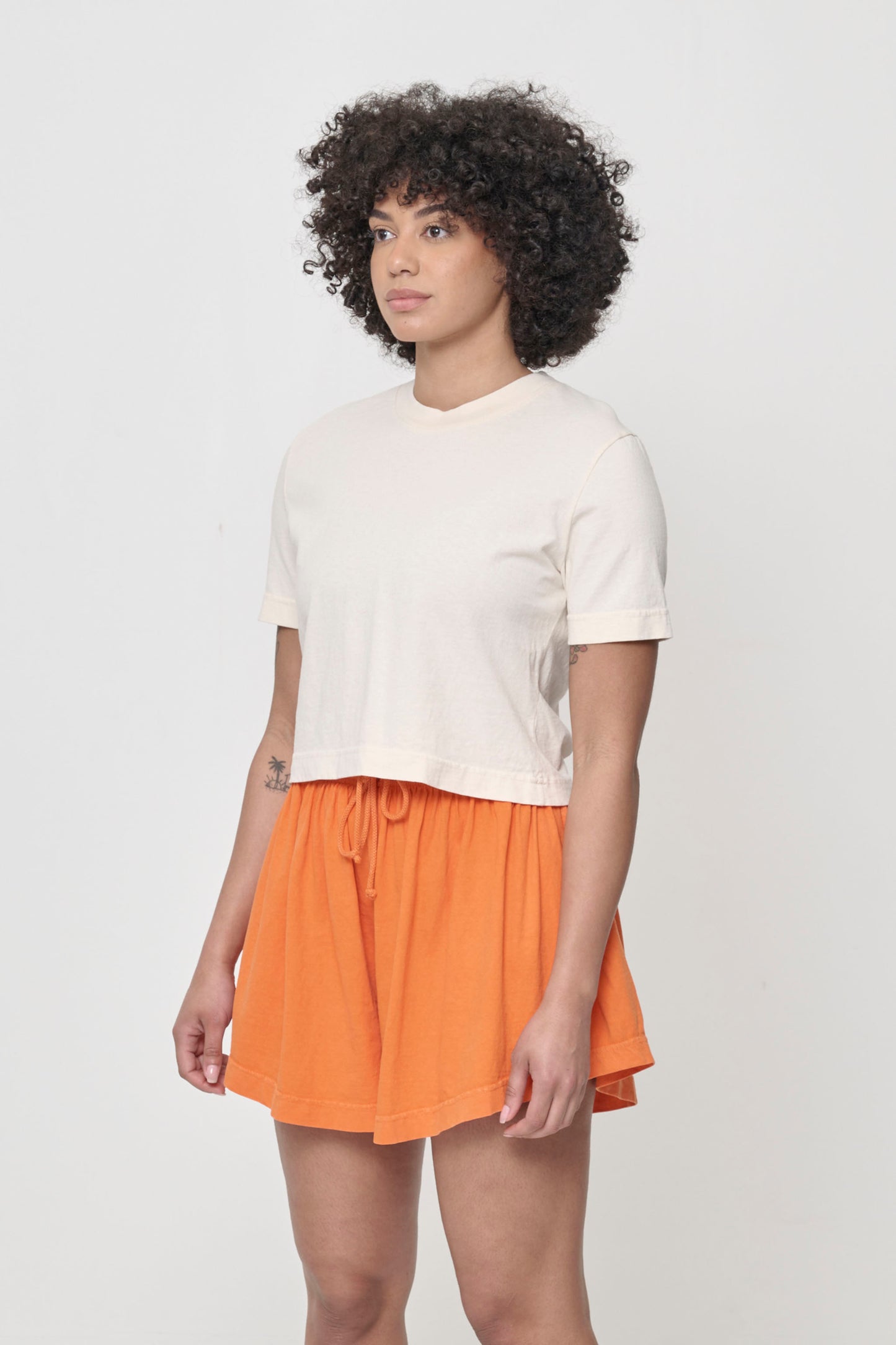3/4 front view showing relaxed yet slim short sleeves and side seams.