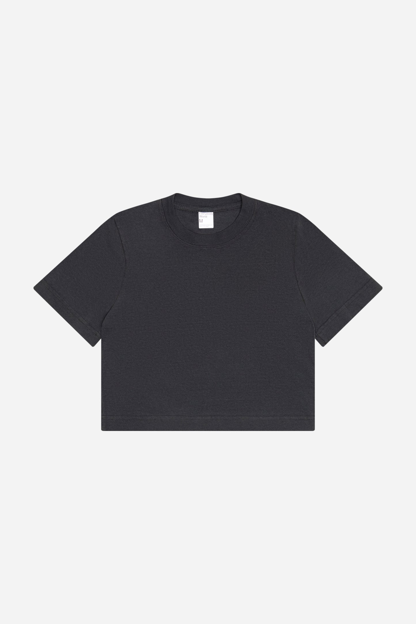 Flat lay showing dark gray t-shirt's silhouette and construction details