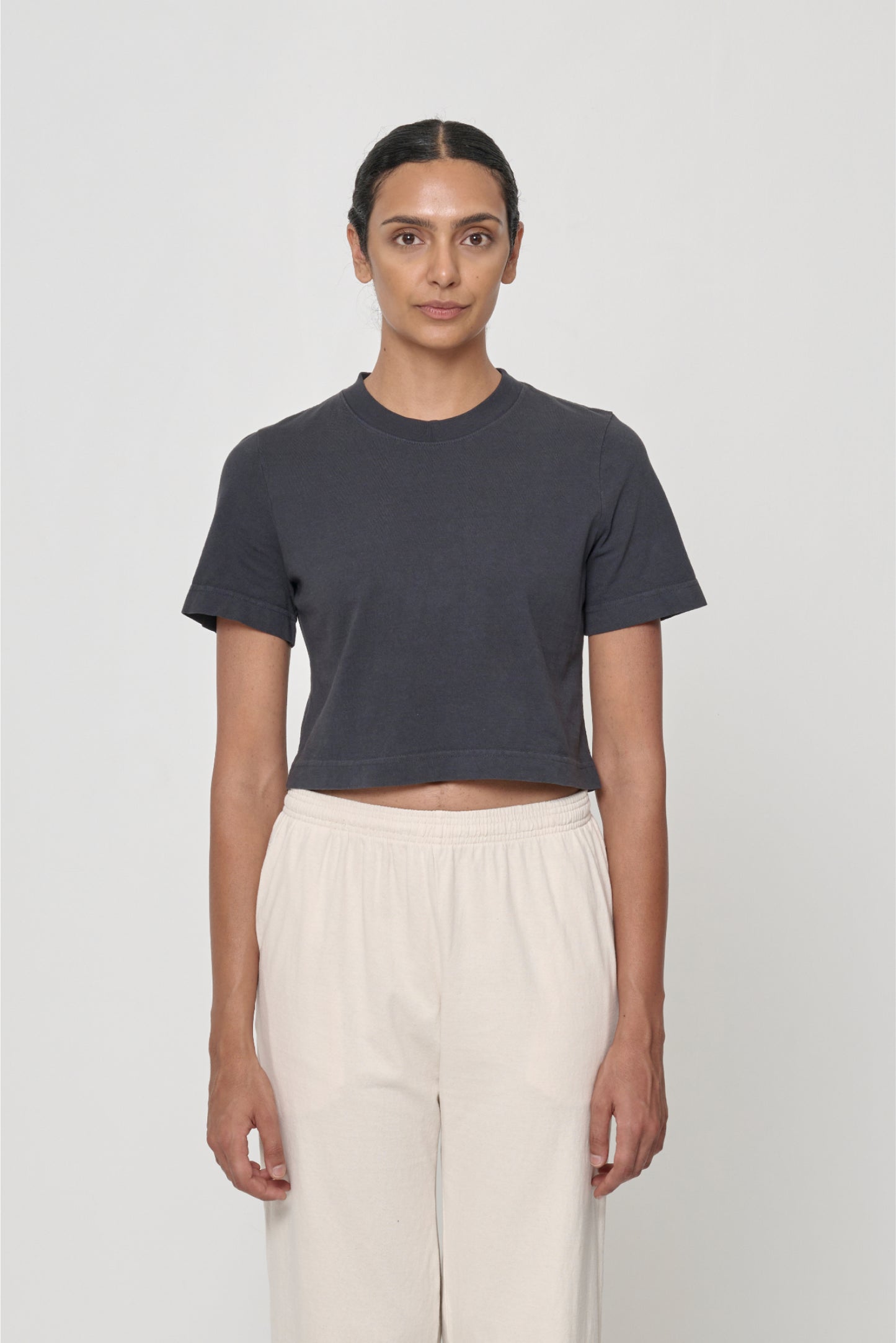Size S - 5'10" woman wearing cropped tee with lower hem hitting her navel