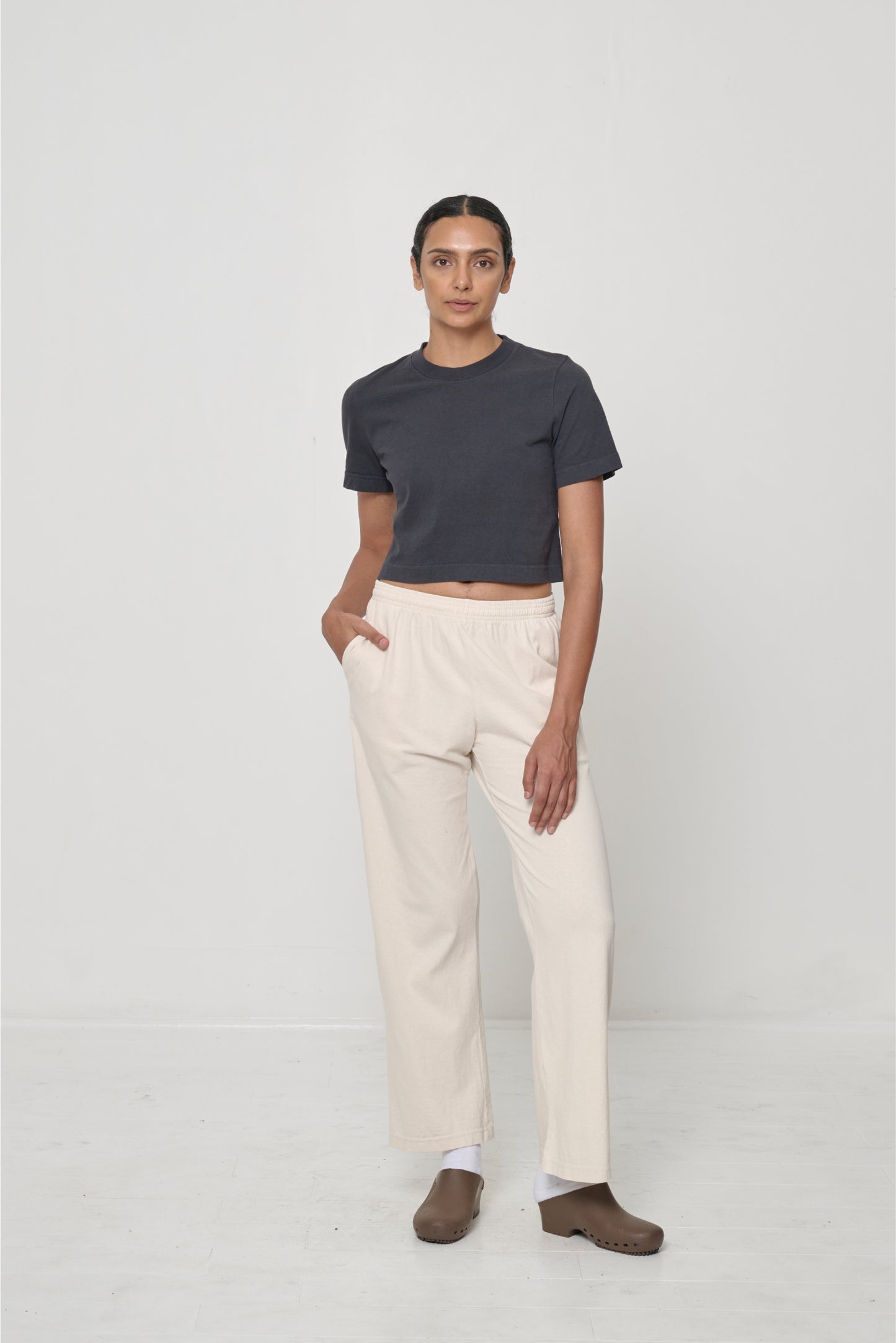 size S - 5'10" woman wearing cropped tee with lower hem hitting her navel