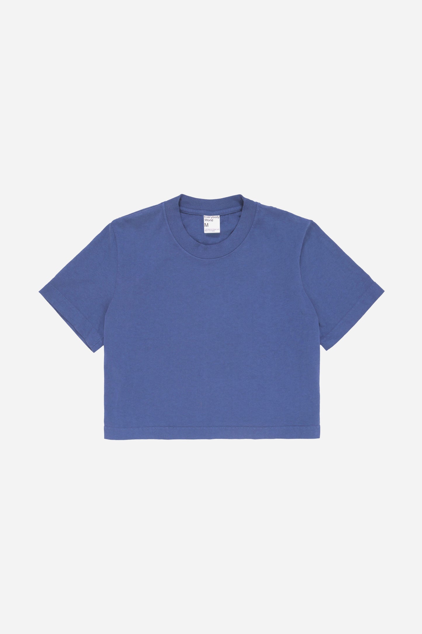 Flat lay showing dark blue t-shirt's silhouette and construction details