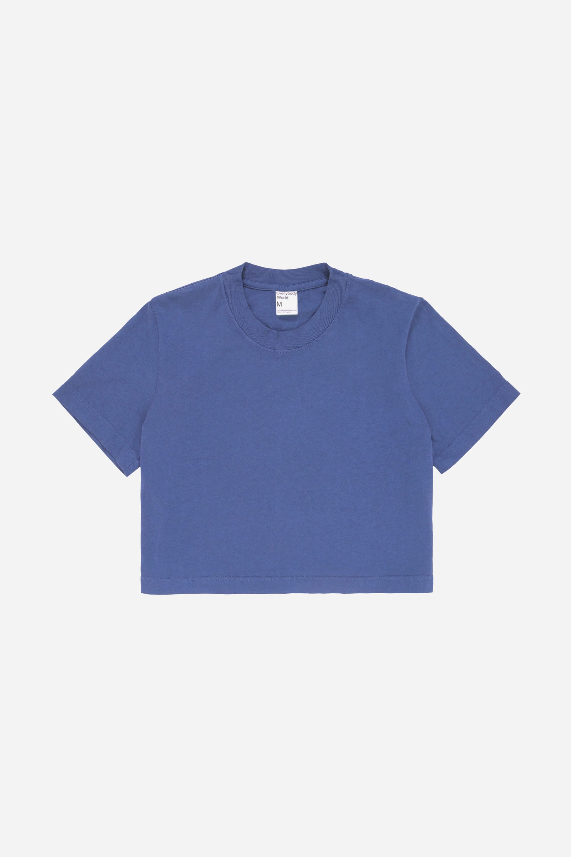 Flat lay showing dark blue t-shirt's silhouette and construction details