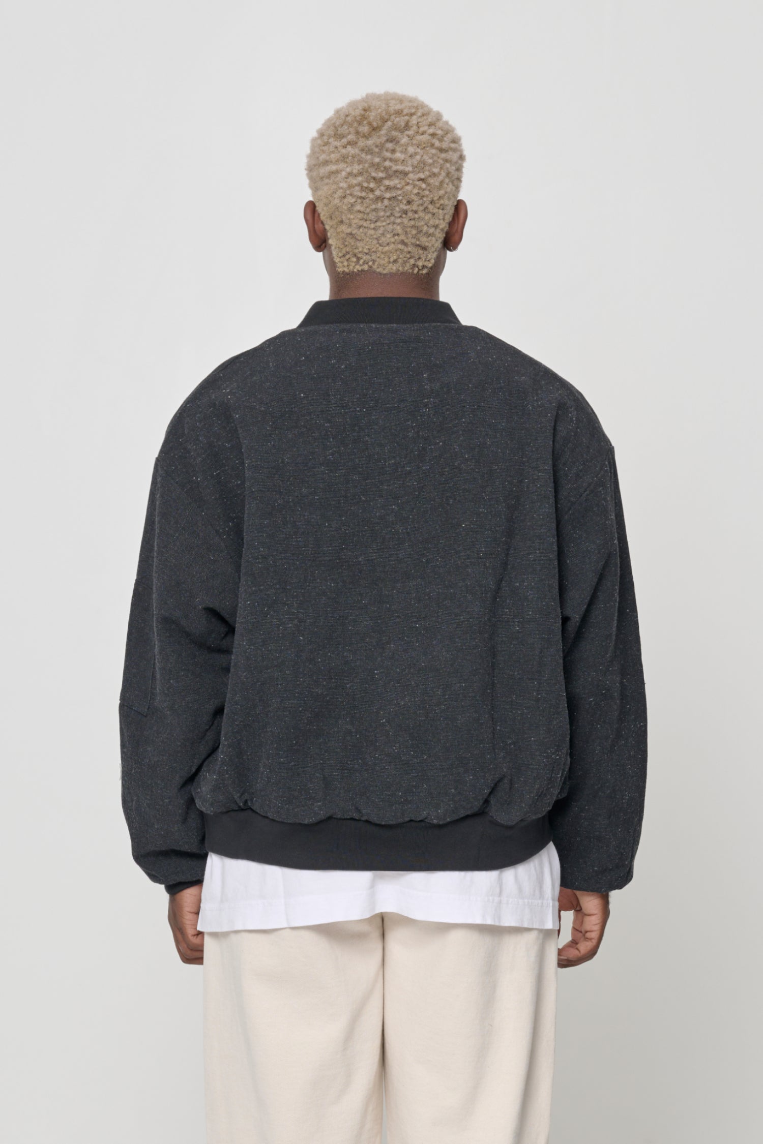 Back view with jacket pulled down to mid hip.