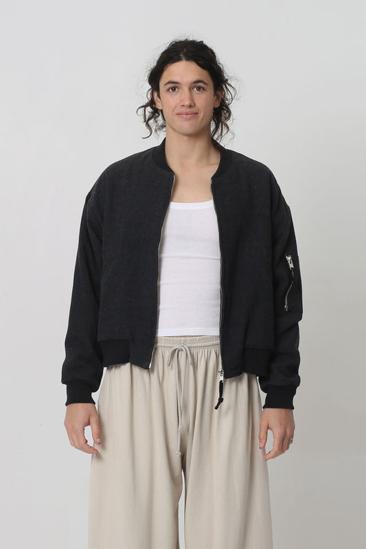 6' person in a size M Biodegradable Bomber Jacket in Black. Hem ends at their upper hip.