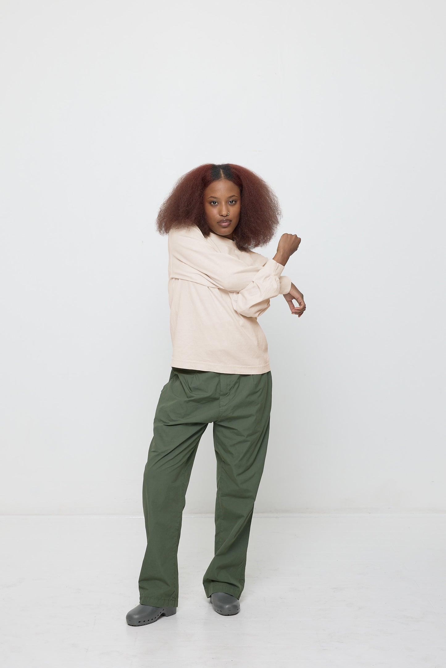 Forearms crossed, demonstrating ease of shirt's movement.