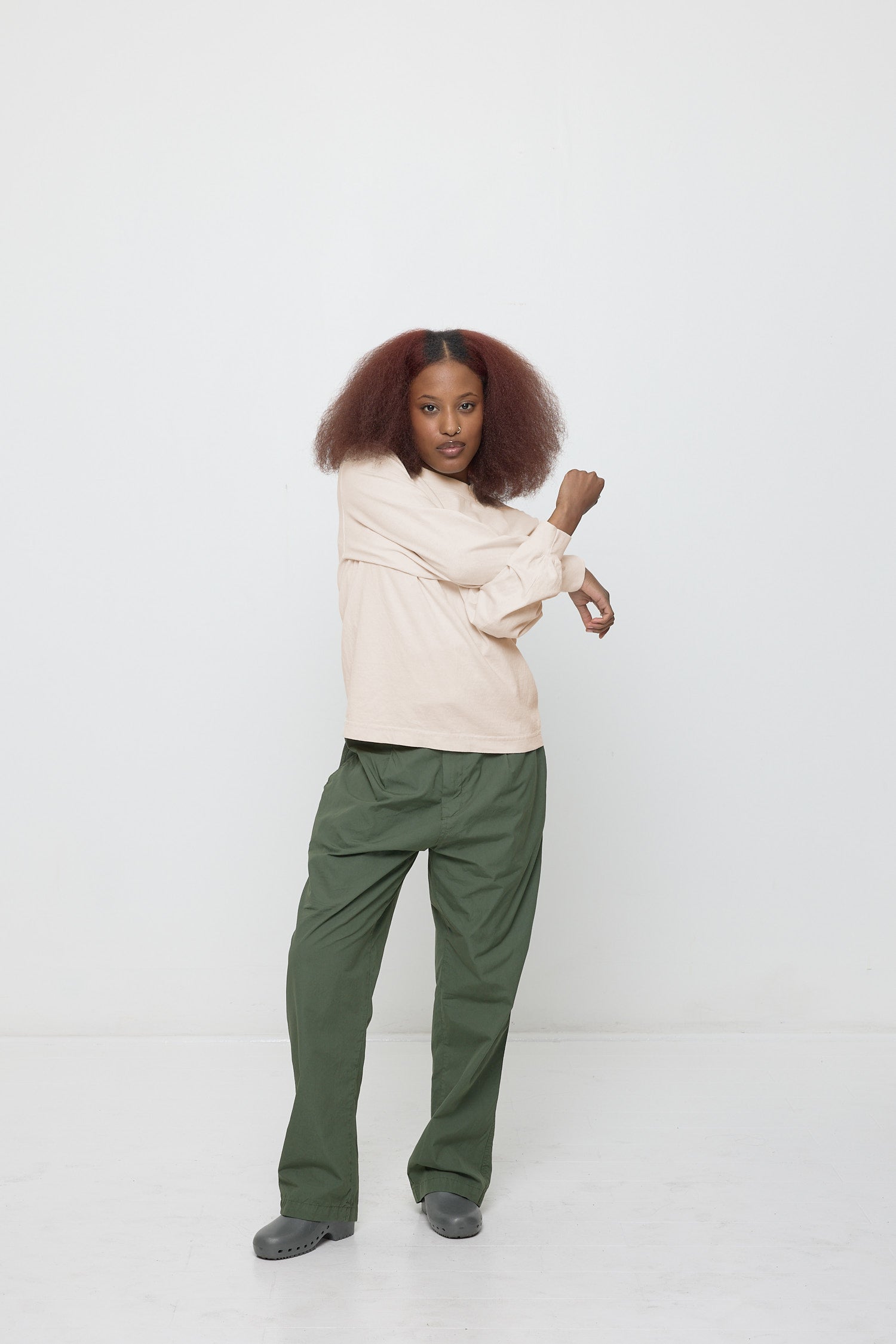 Forearms crossed, demonstrating ease of shirt's movement.