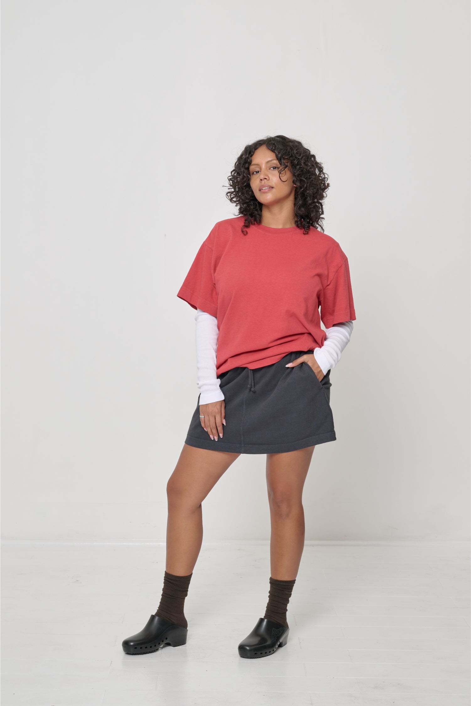 One hand in skirt pocket to show texture of the t-shirt fabric.