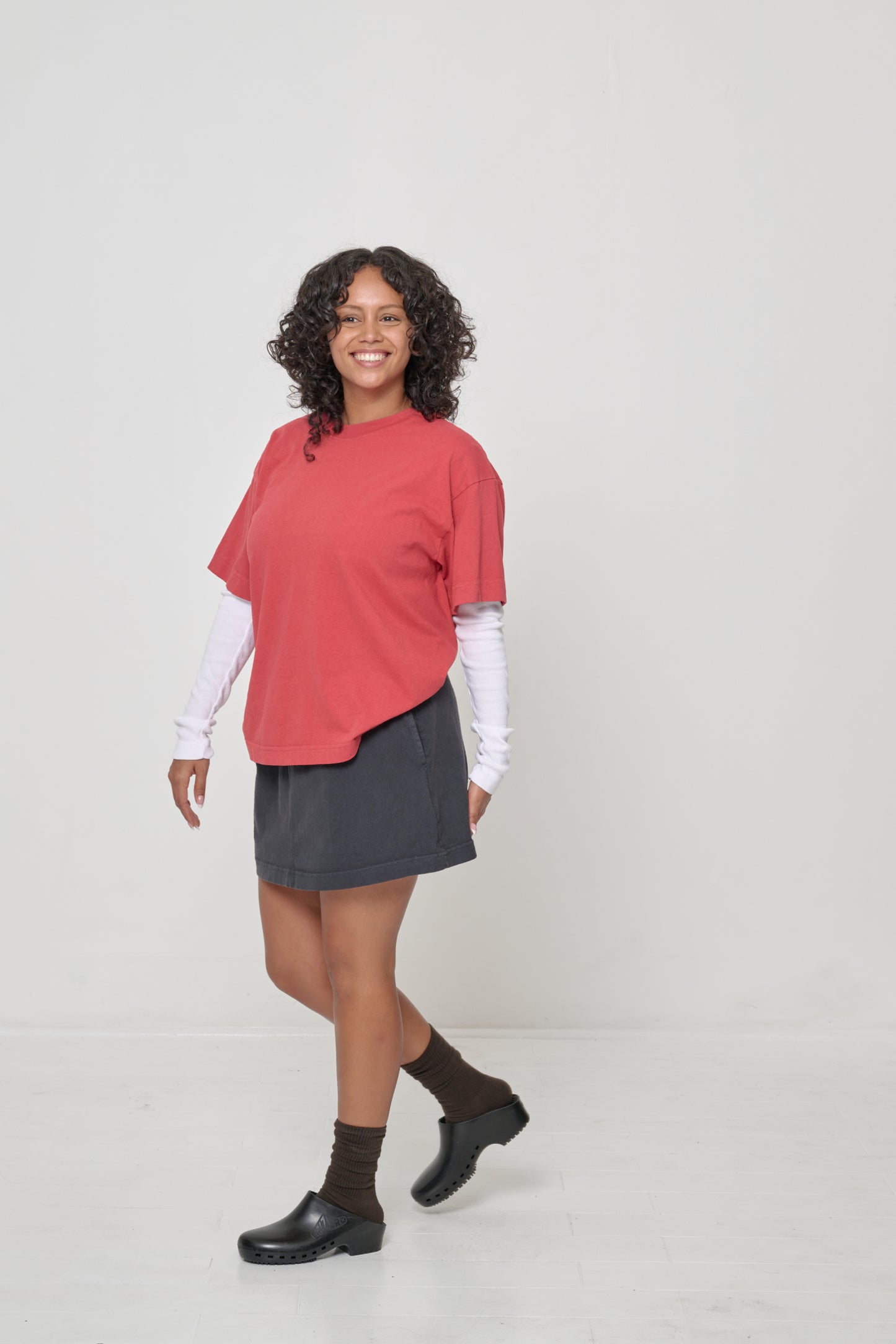 Woman swiveling her torso to show lack of side seams.