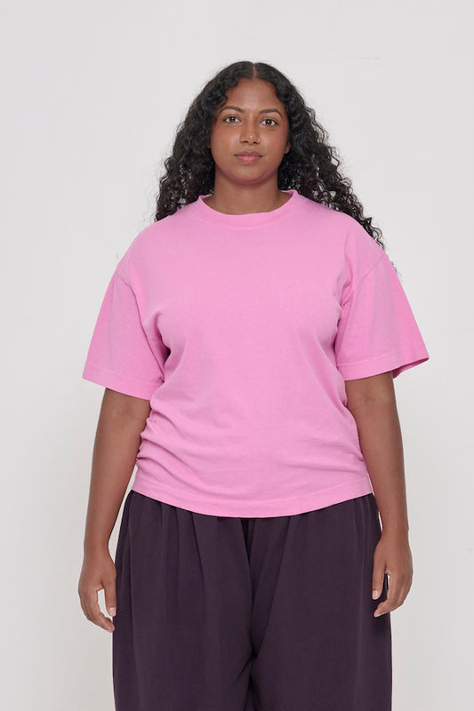 A 5'8" woman in a size M medium pink tee. Bottom hem at the mid upper hip.