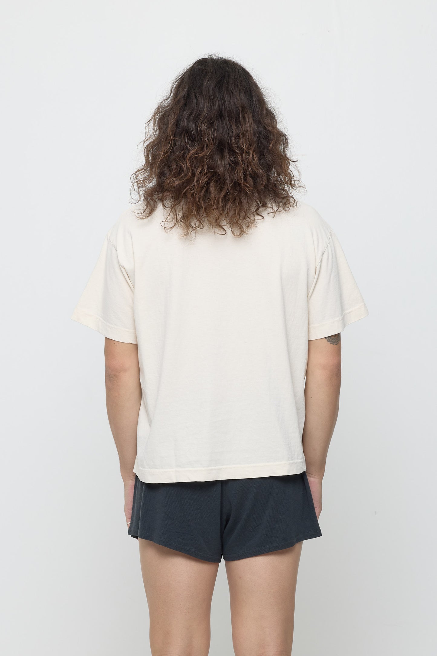 Back view showing fabric drape and relaxed fit throughout.