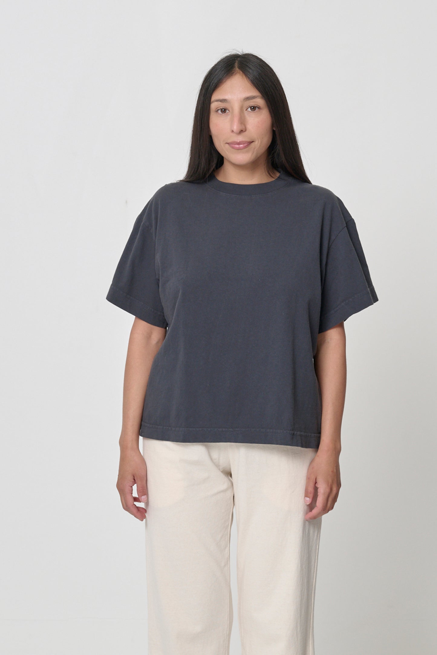 A 5'4" woman in size S. Bottom hem at her lower middle hip.