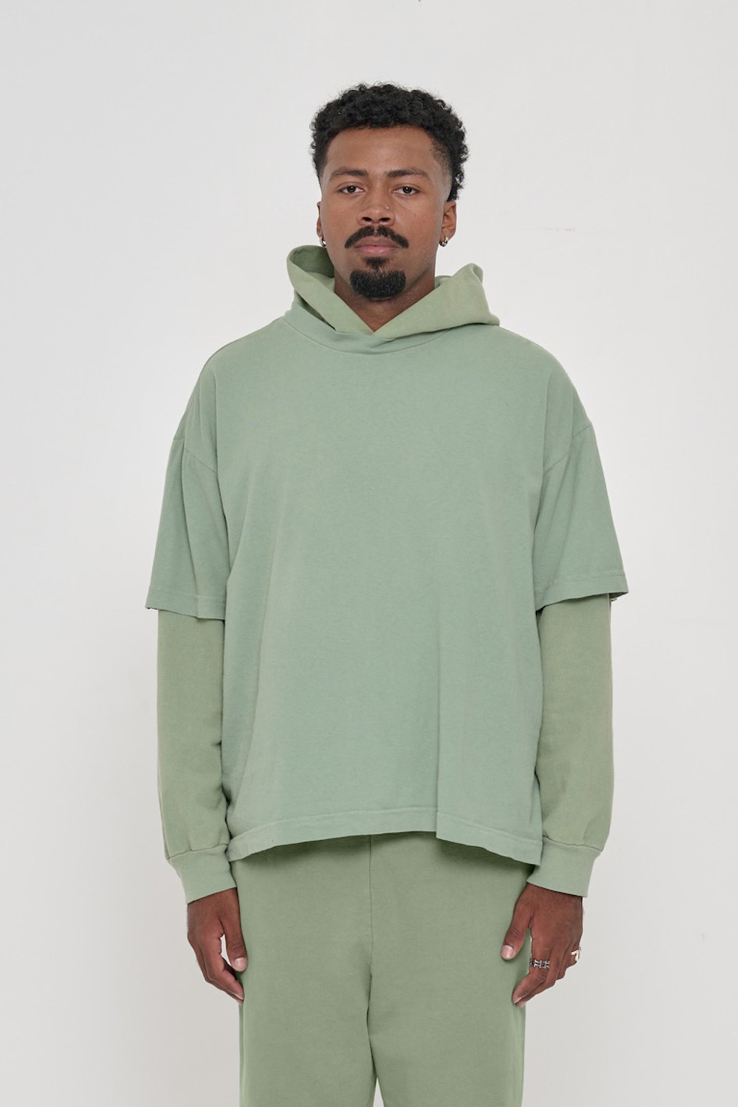 A 6'2" man in XL Wasabi light green Boxier Trash Tee. Bottom hem at his lower hip.