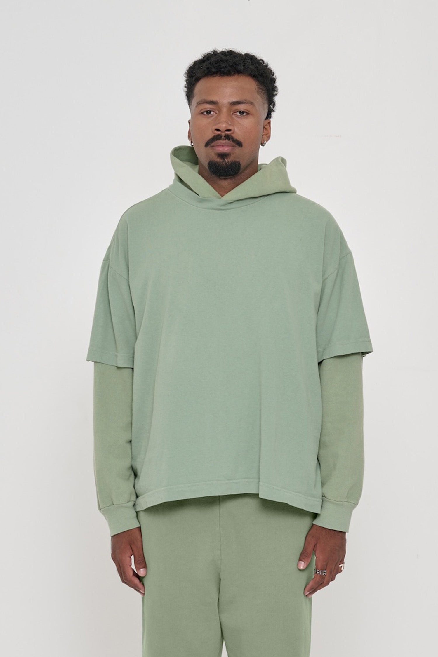 A 6'2" man in XL Wasabi light green Boxier Trash Tee. Bottom hem at his lower hip.