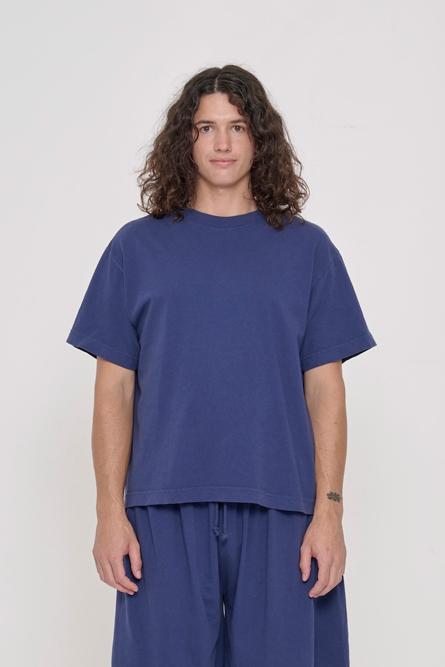 Front view of a 6' person wearing a Washed Navy Boxier Trash Tee in size M. Hem at lower-middle hip.