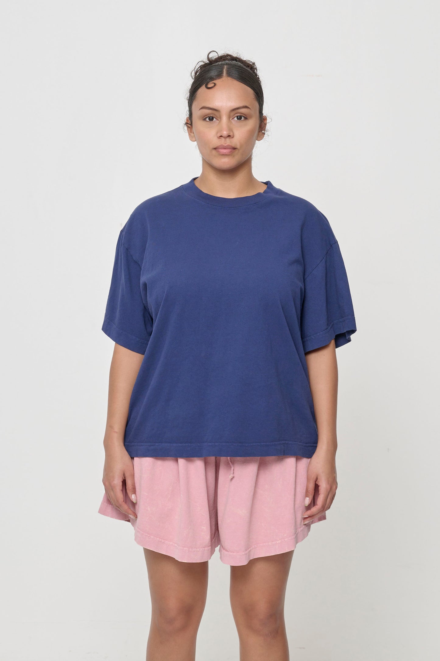A 5'7" woman in a size M Washed Navy (dark blue) Boxier Trash Tee. Hem of shirt hits her lower hip.