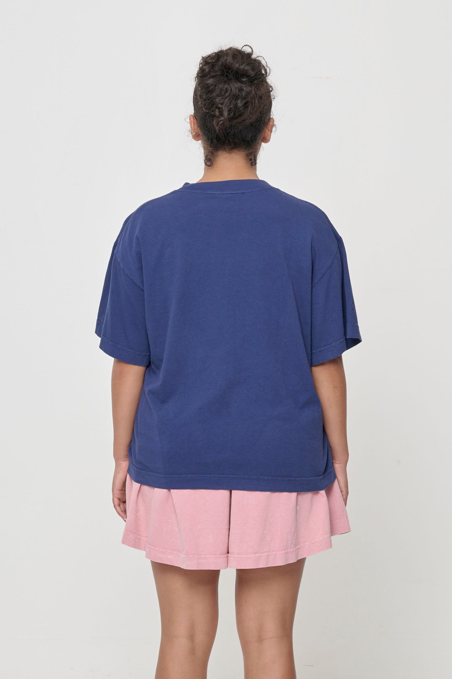 Back view showing fabric drape and relaxed fit throughout.