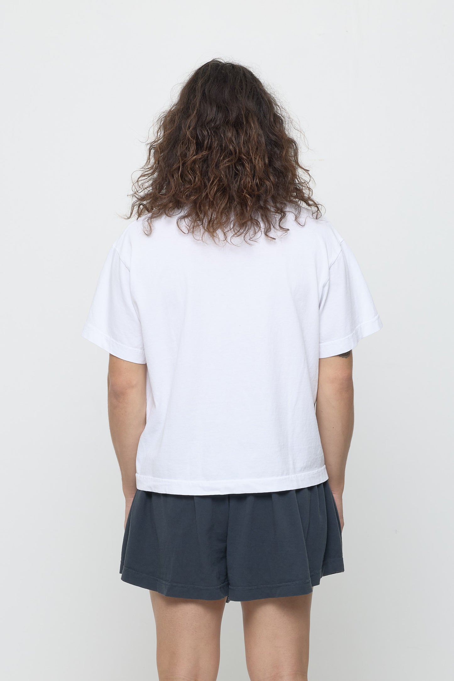 Boxier Trash Tee in White - back view showing fabric drape and relaxed fit throughout.
