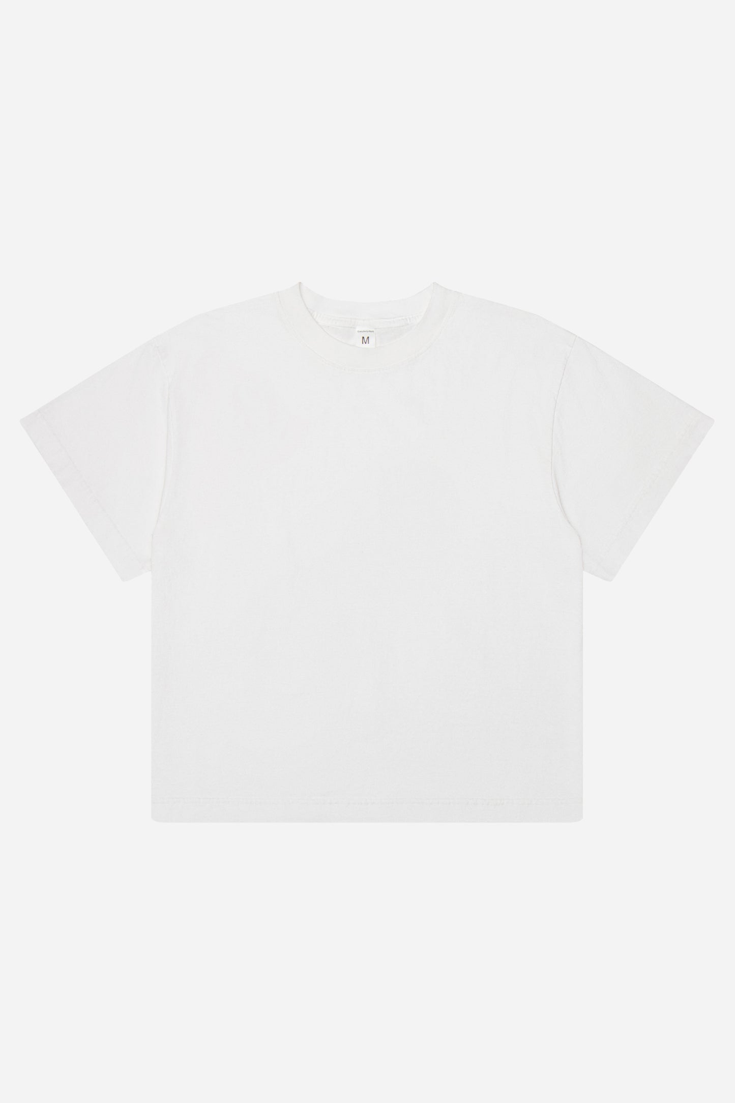 Flat lay of White Boxier Trash Tee showing the straight boxy cut of the t-shirt.