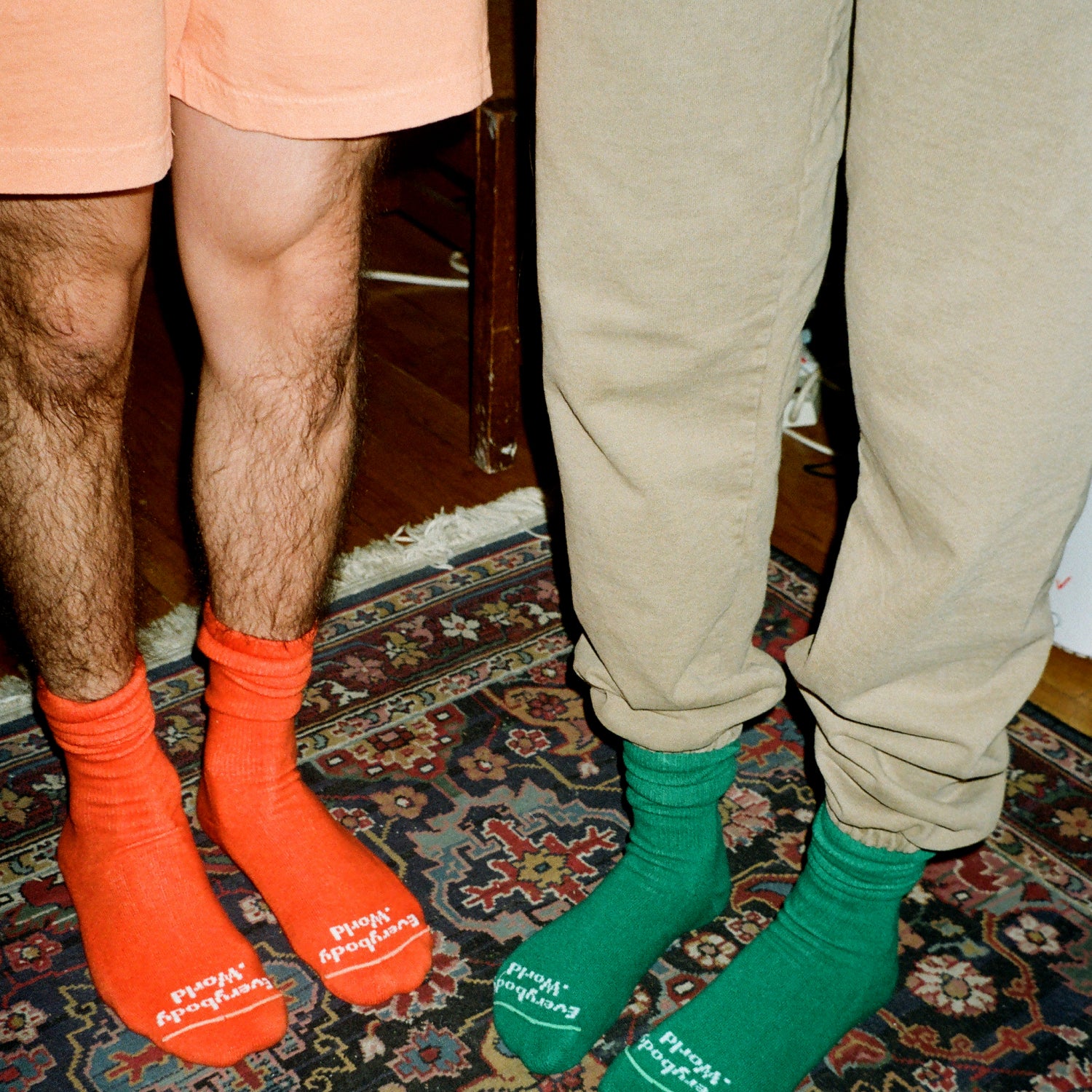 Two models at home in New York wearing Squishy Socks and standing on a rug