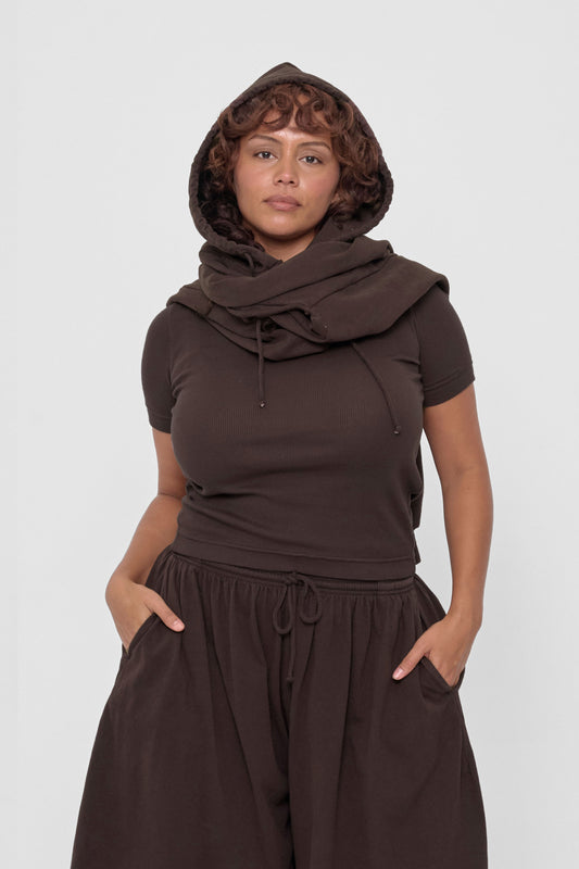 Clyde x Everybody.World Hoodie Scarf in Wet Soil – front view on model, worn with hood on and sleeves wrapped around neck