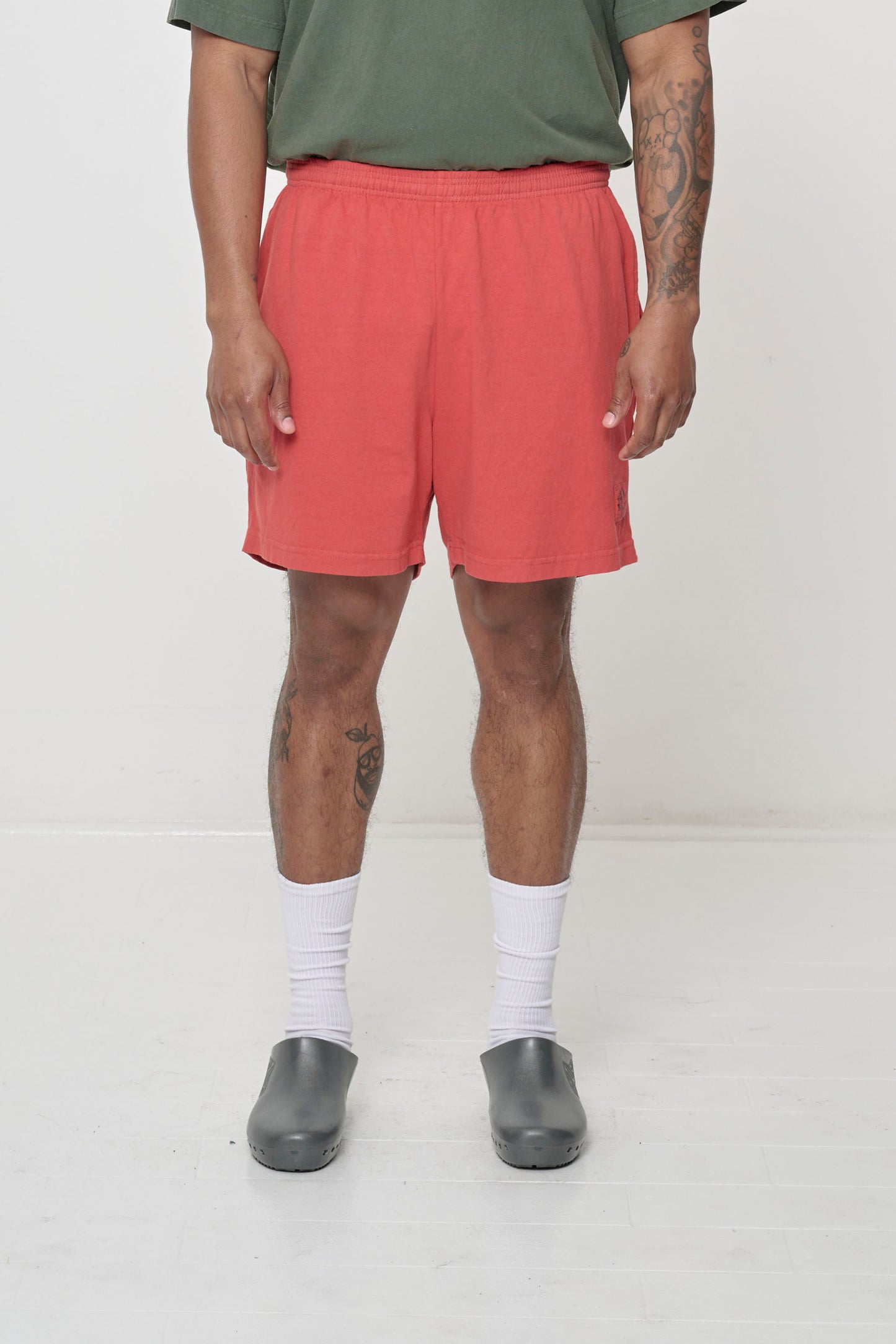 Orange-red Cedar Shorts on model, front view.