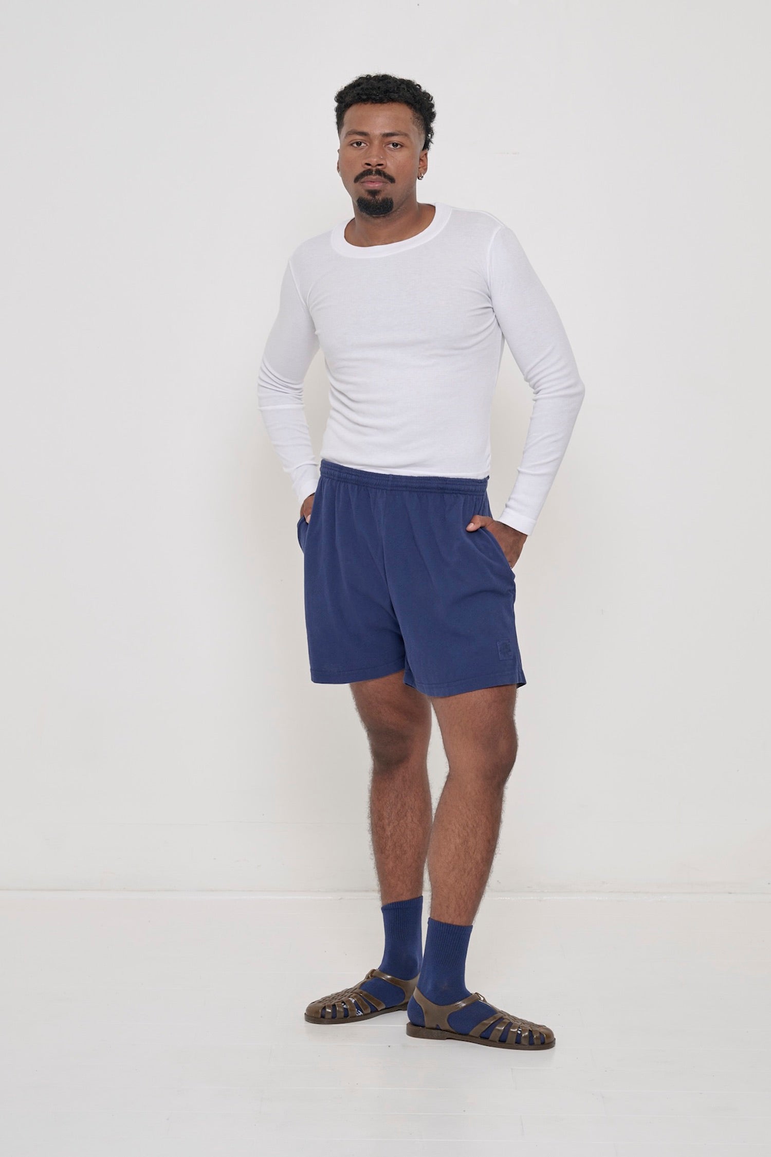 White Rib Long Sleeve tucked into waist of the shorts.