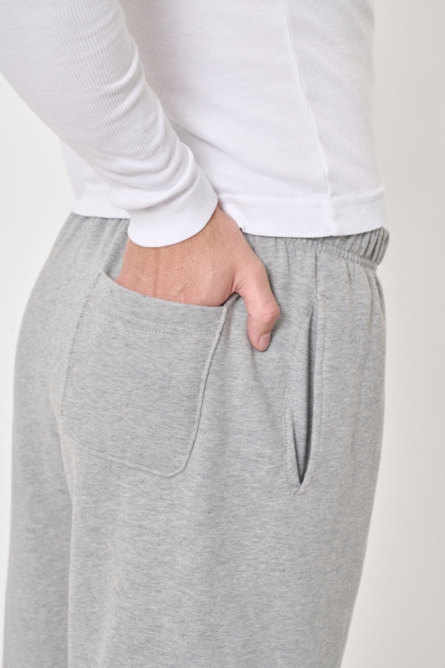 Zoom in on Heather Sweatpants to show model's hand in the back patch pocket.