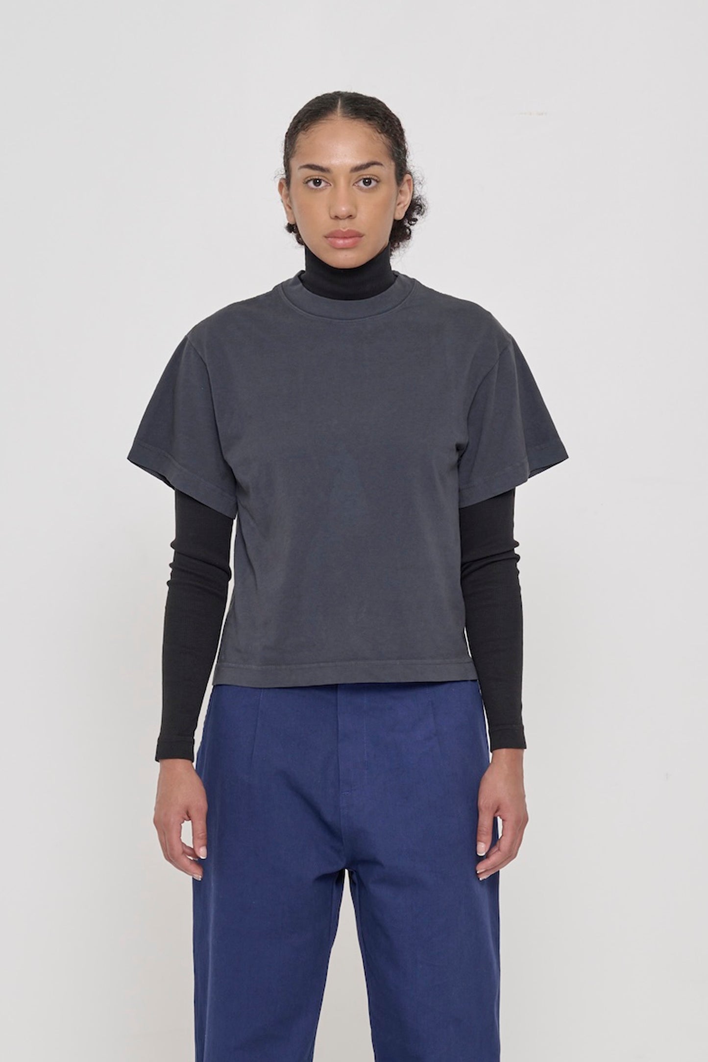 A 5'8" woman wearing Slate Heavyweight Boxier Trash Tee in size XS. Bottom hem cropped to upper hip.