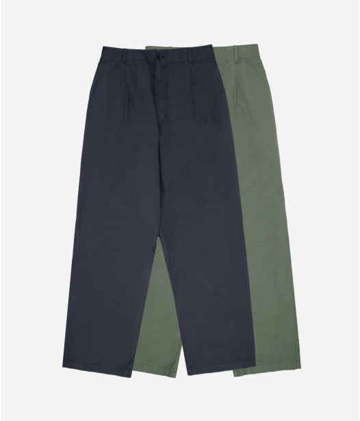 Flat lay of Slate grey Life Uniform Pants on top of a Pine green pair, showing contrast between the two colors.