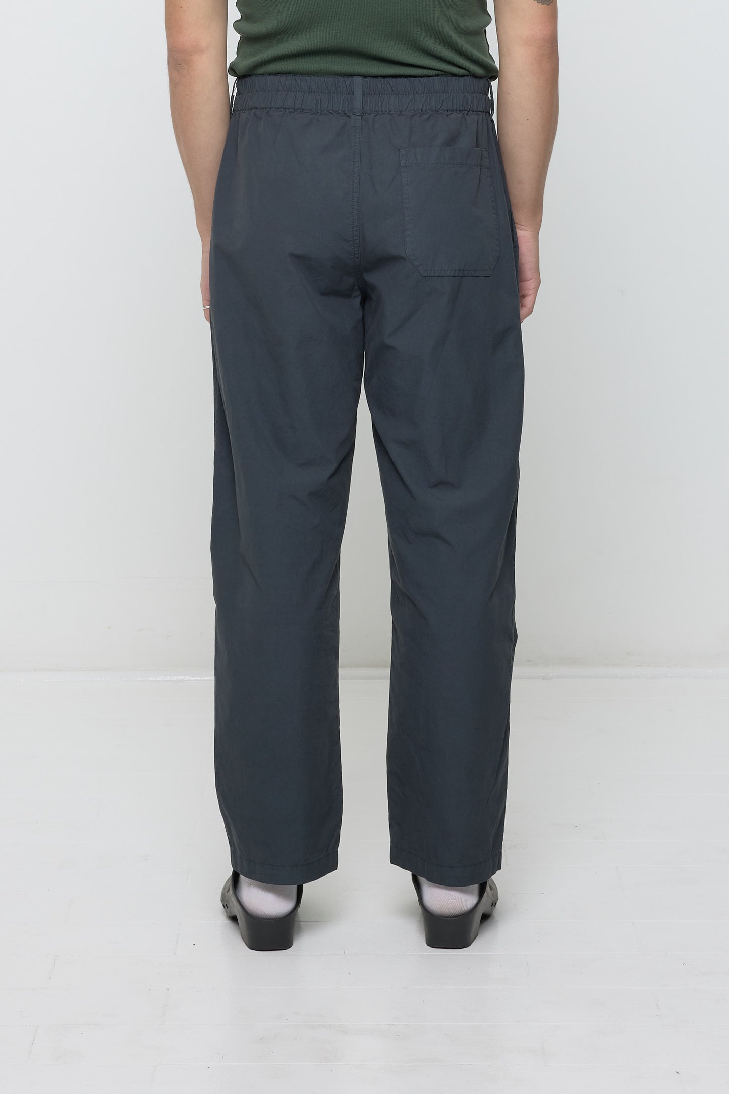 Lower back view of a person wearing Life Uniform Pants in Slate. Shows elasticized back waistband and right back pocket.