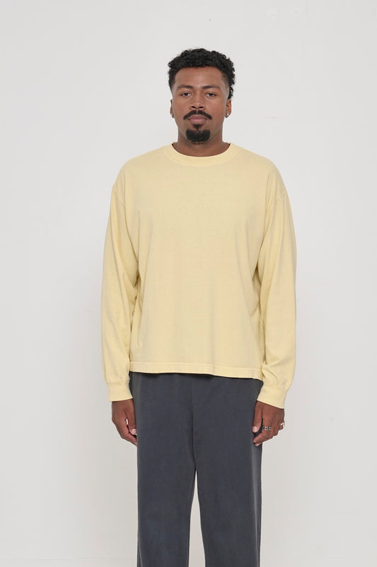 A 6'2" man in a French Butter Long Sleeve Boxier Trash Tee size L. Hem at his lower hip.