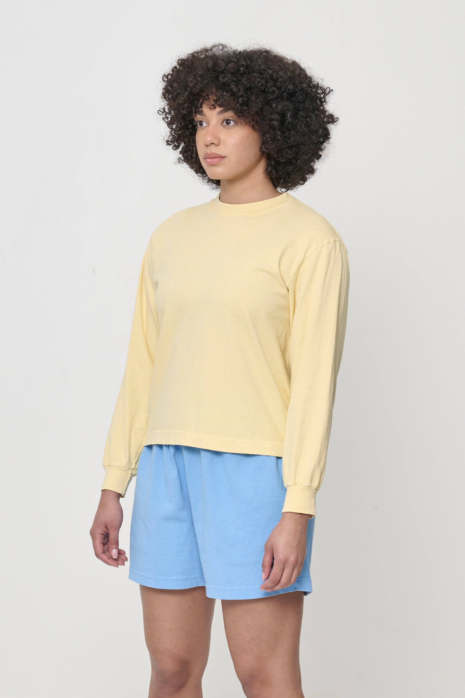 Facing 45-degrees from the front highlighting the relaxed sleeves and rib cuff.
