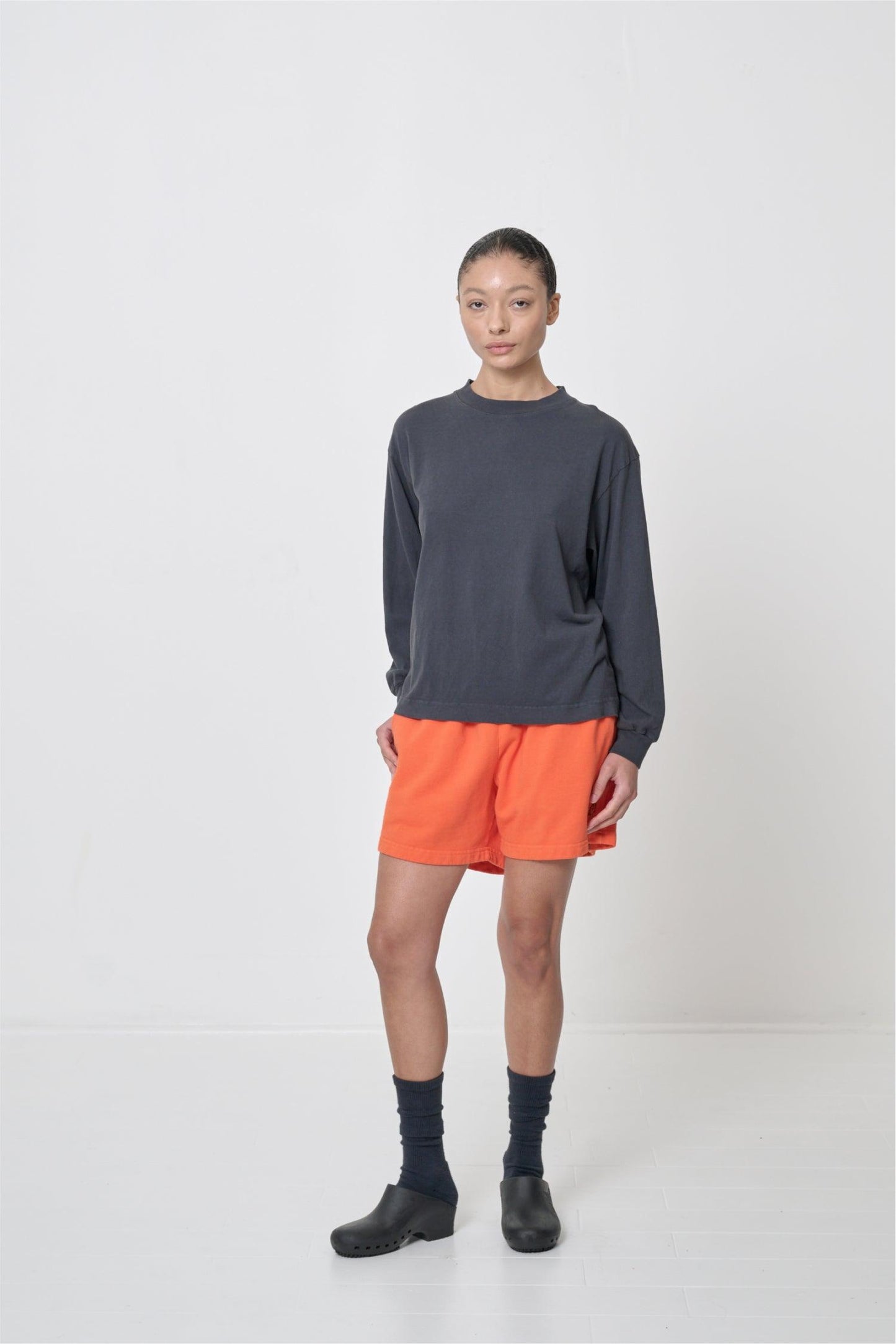 Styled with orange Everyday Shorts and Black Calzuro Classic Clogs.