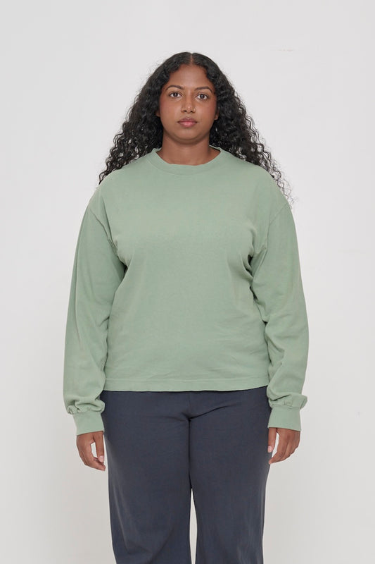 A 5'8" woman in a size M Wasabi Long Sleeve Boxier Trash Tee. Shirt hem hits the mid hip.