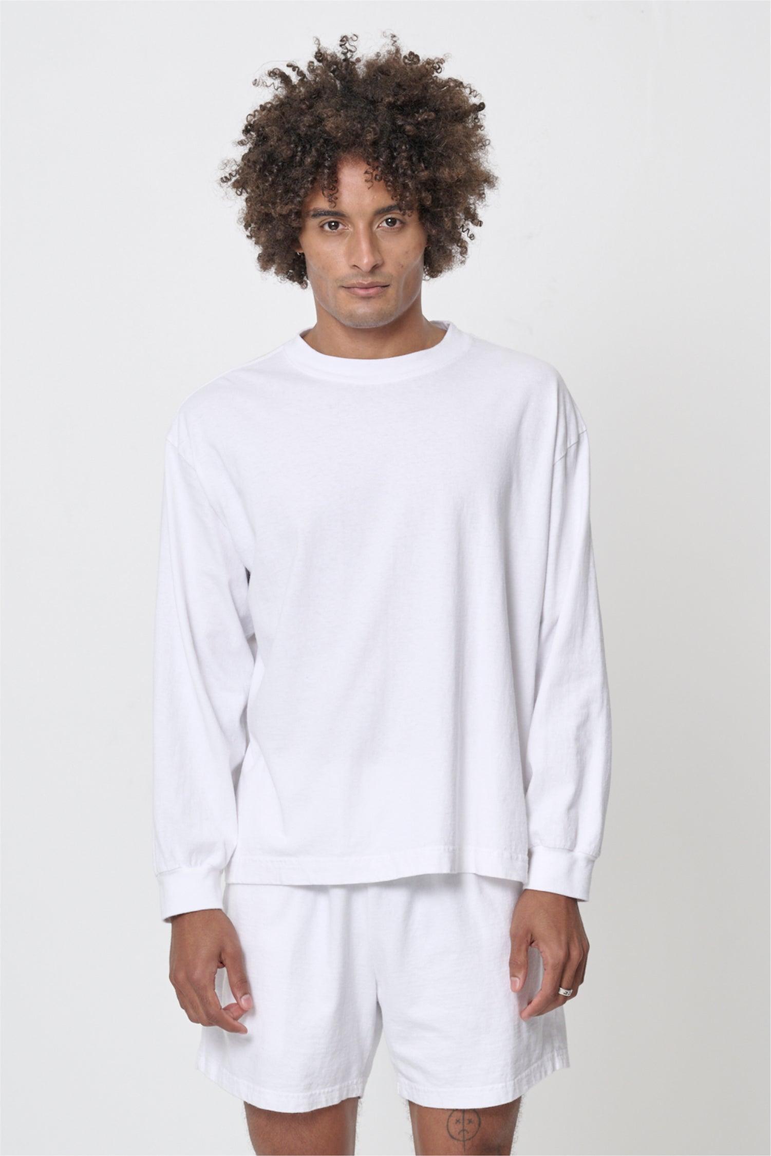 A 6'0" man in a size M White Long Sleeve Boxier Trash Tee. Hem hits his lower middle hip.