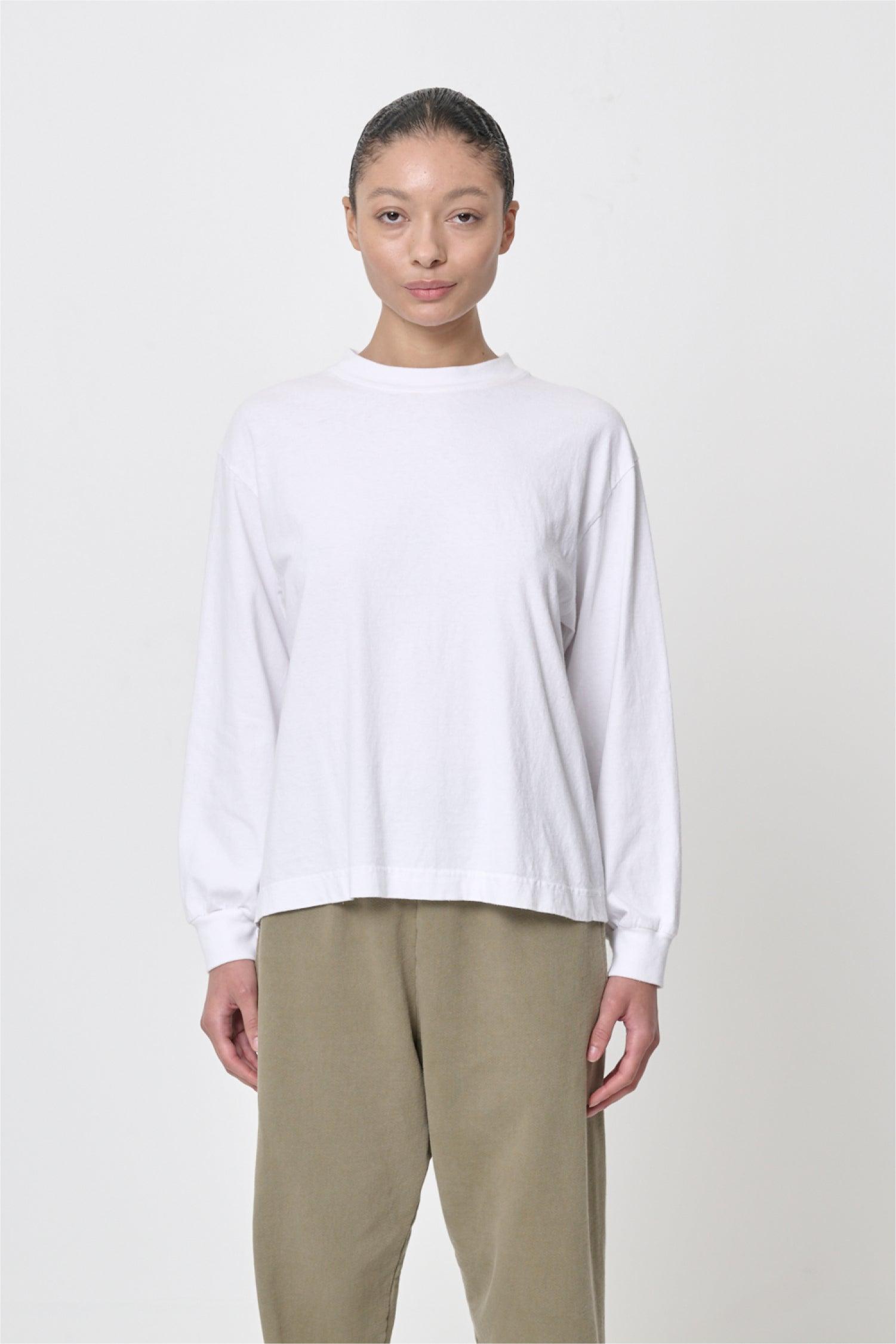 A 5'8" woman in a size S White Long Sleeve Boxier Trash Tee. Hem hits the middle of her hip.