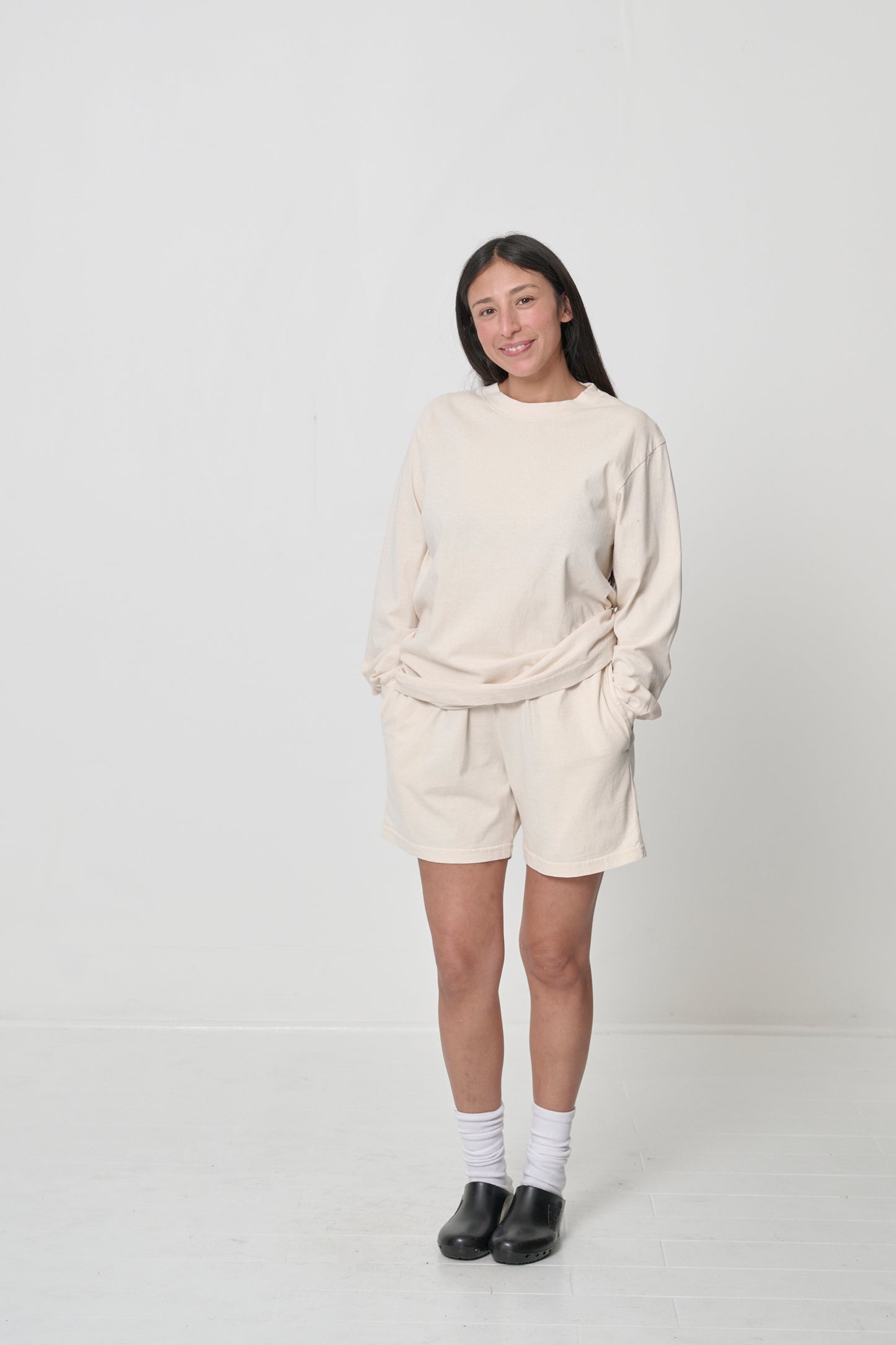 Woman in Scour Long Sleeve Trash Tee and Everyday Shorts (hands in pockets) highlights relaxed fit and drape.