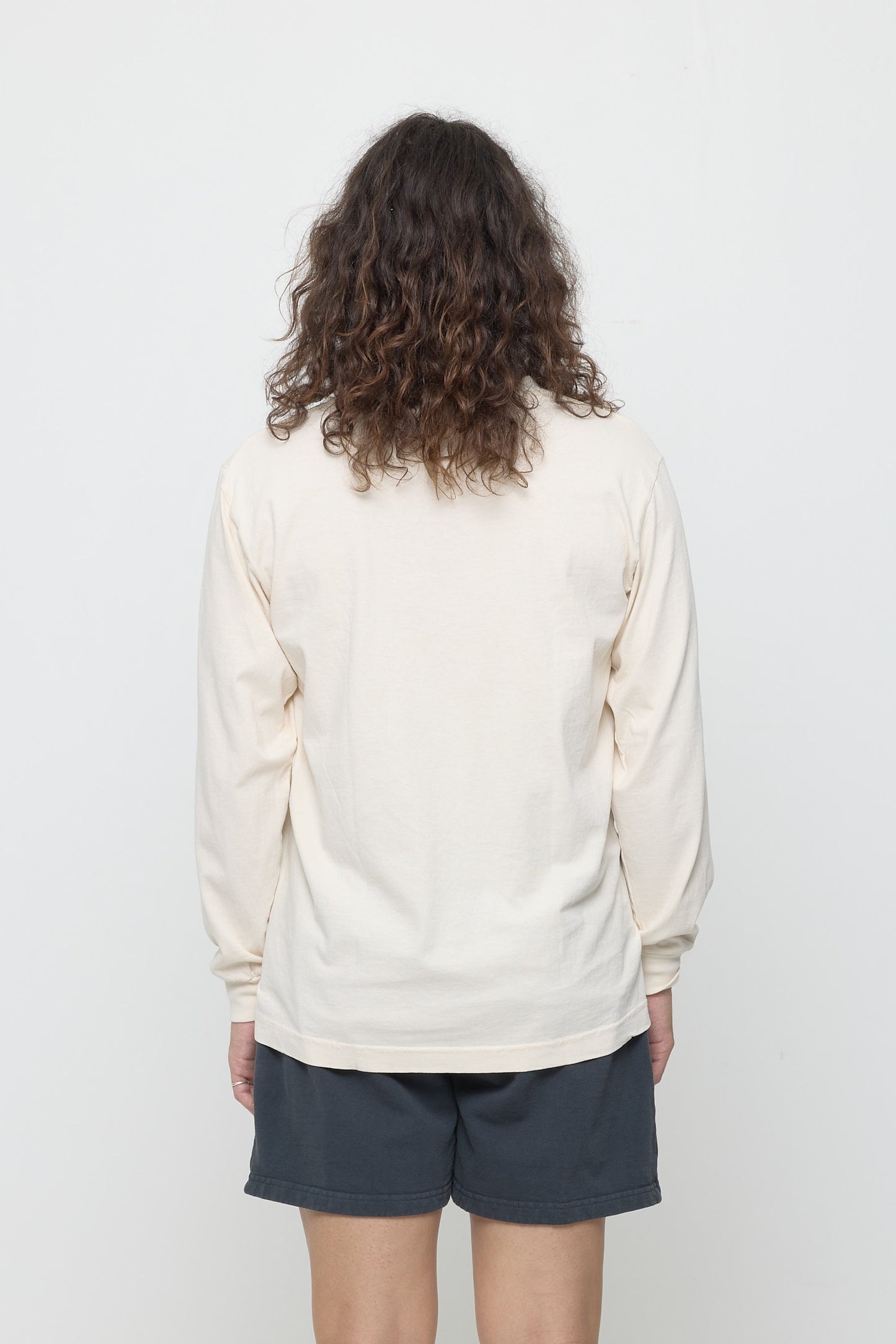 Back view: person wearing a Scour Long Sleeve Trash Tee, showing fabric drape and relaxed fit throughout.